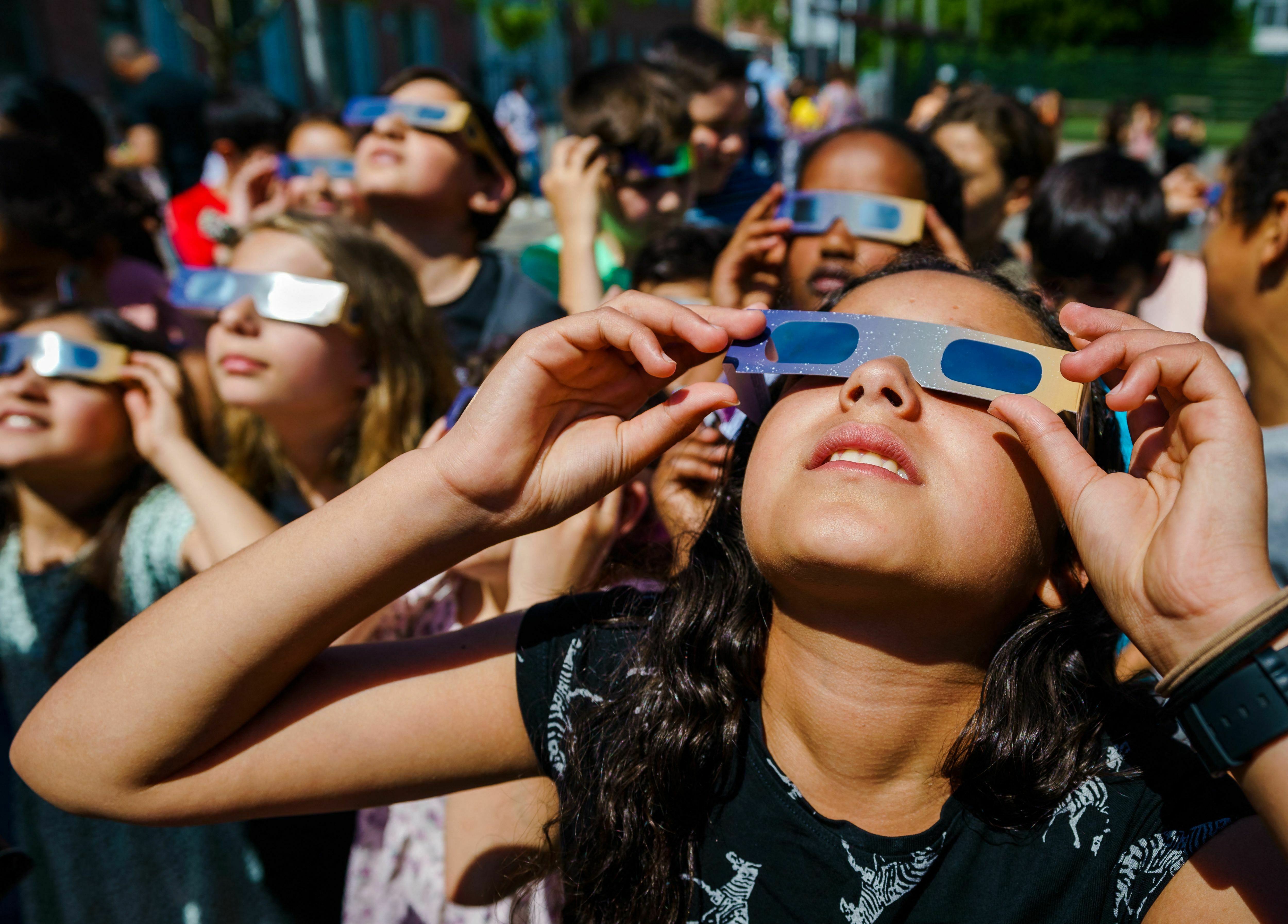 Pupils, wearing protective glasses, look at the partial solar eclipse in Schiedam, the Netherlands, on June 10, 2021. (ANP/AFP via Getty Images)