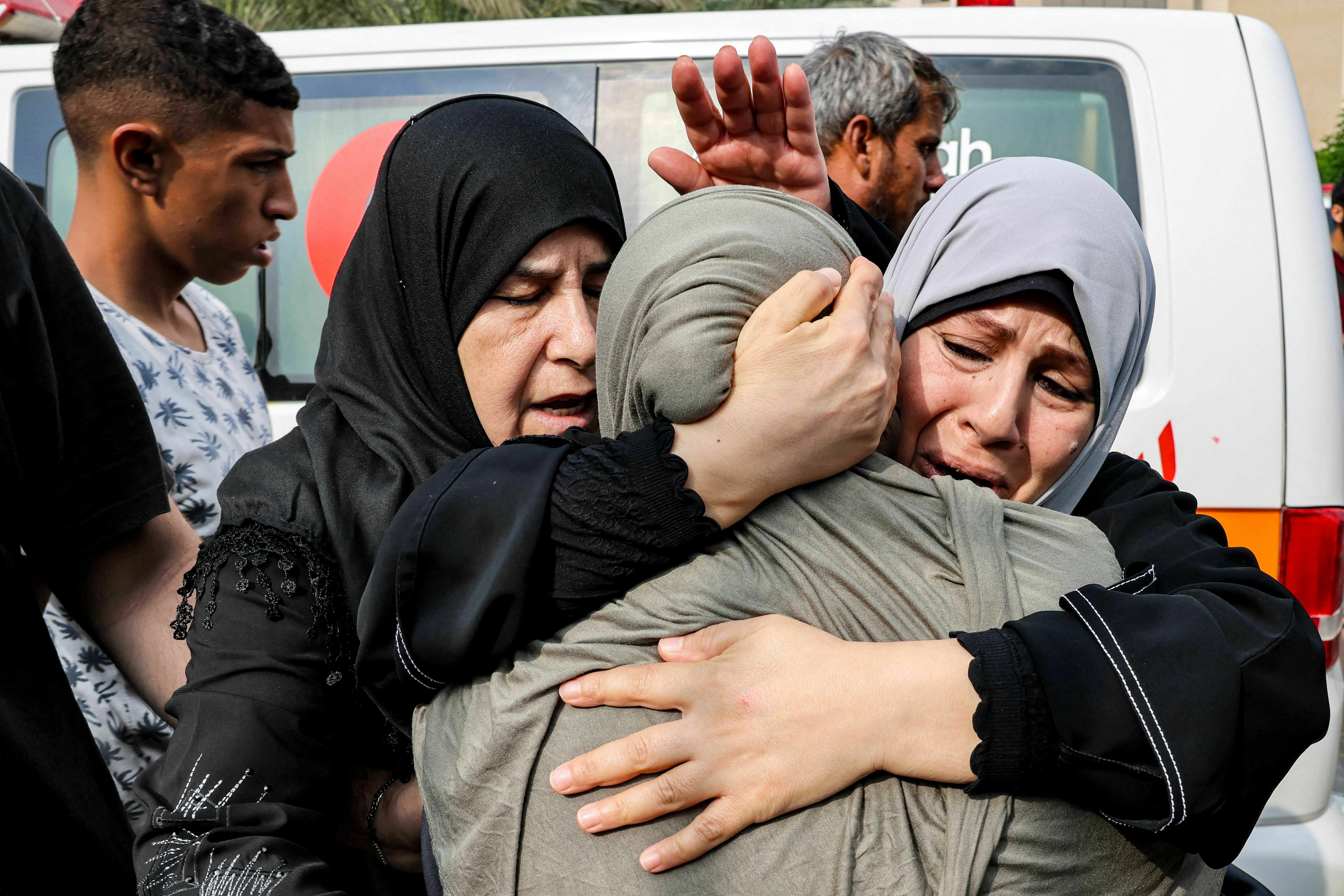 Wed., Oct. 11: Women console another woman mourning for loved ones killed in an Israeli air strike outside a morgue in Khan Yunis in the southern Gaza Strip.
