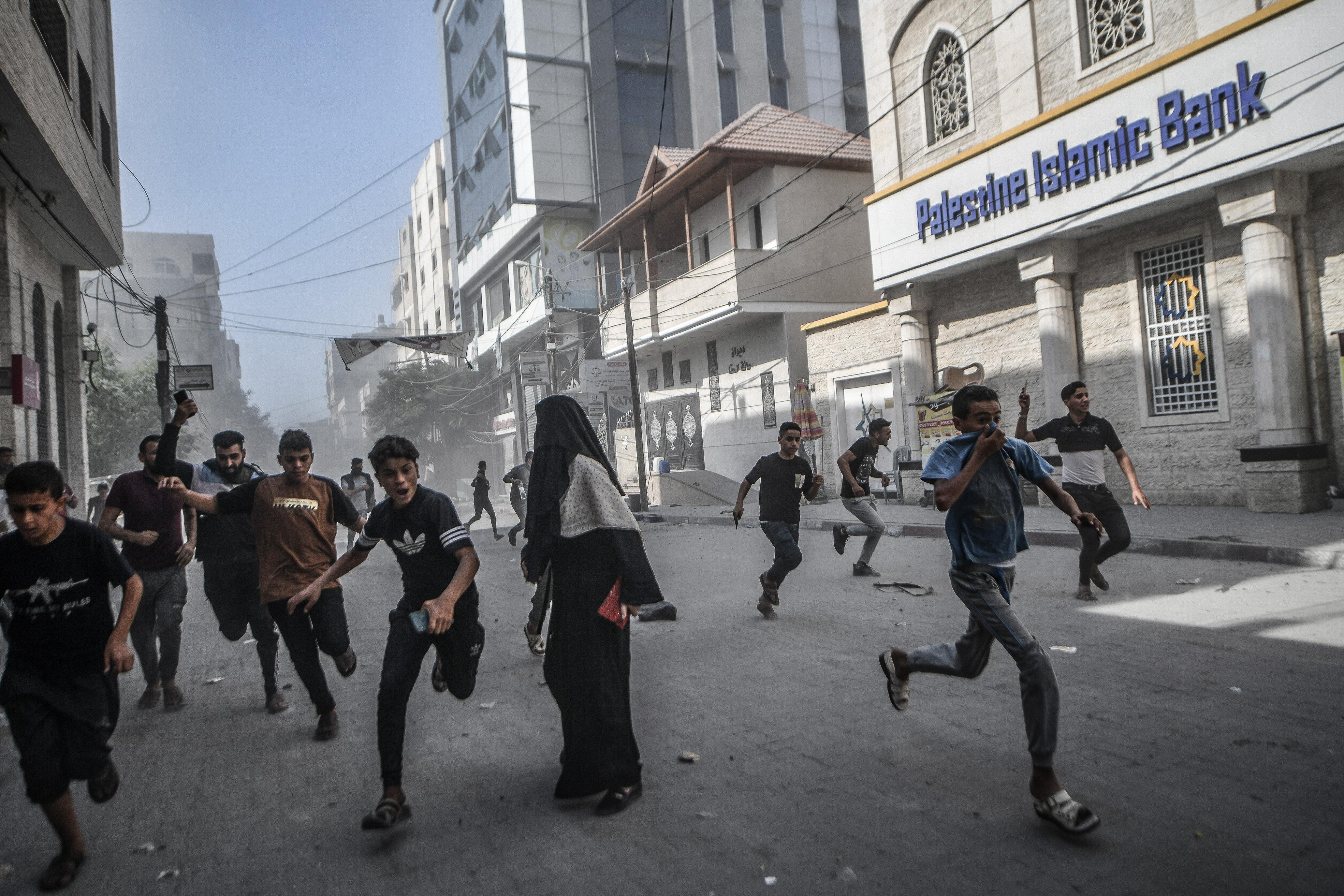 Wed., Oct. 11: Palestinians run away from Israeli airstrikes in Khan Yunis, Gaza.