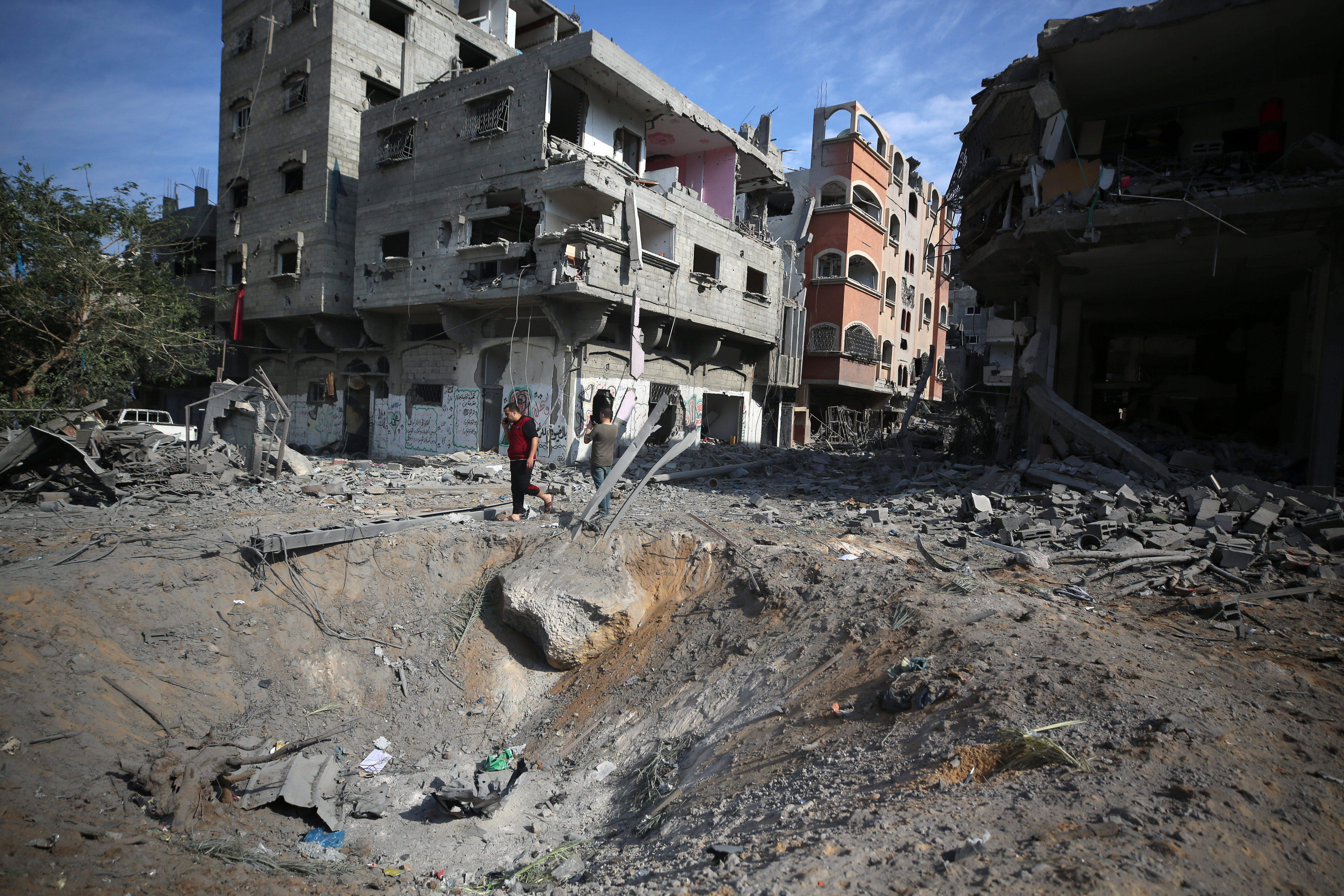 Wed., Oct. 11: A general view shows the destruction as people inspect the damage following overnight Israeli airstrikes in Gaza City.