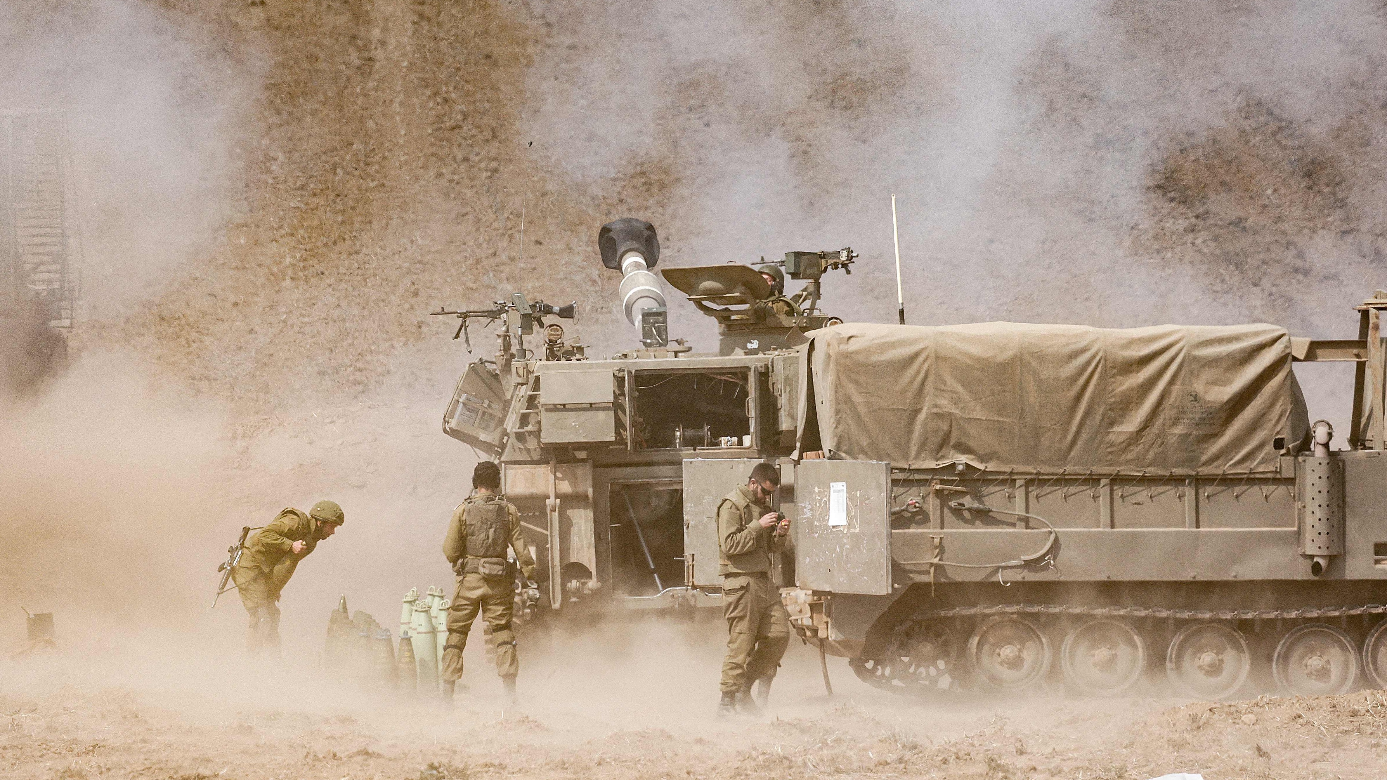 An Israeli army self-propelled howitzer fires rounds near the border with Gaza in southern Israel on Oct. 11.