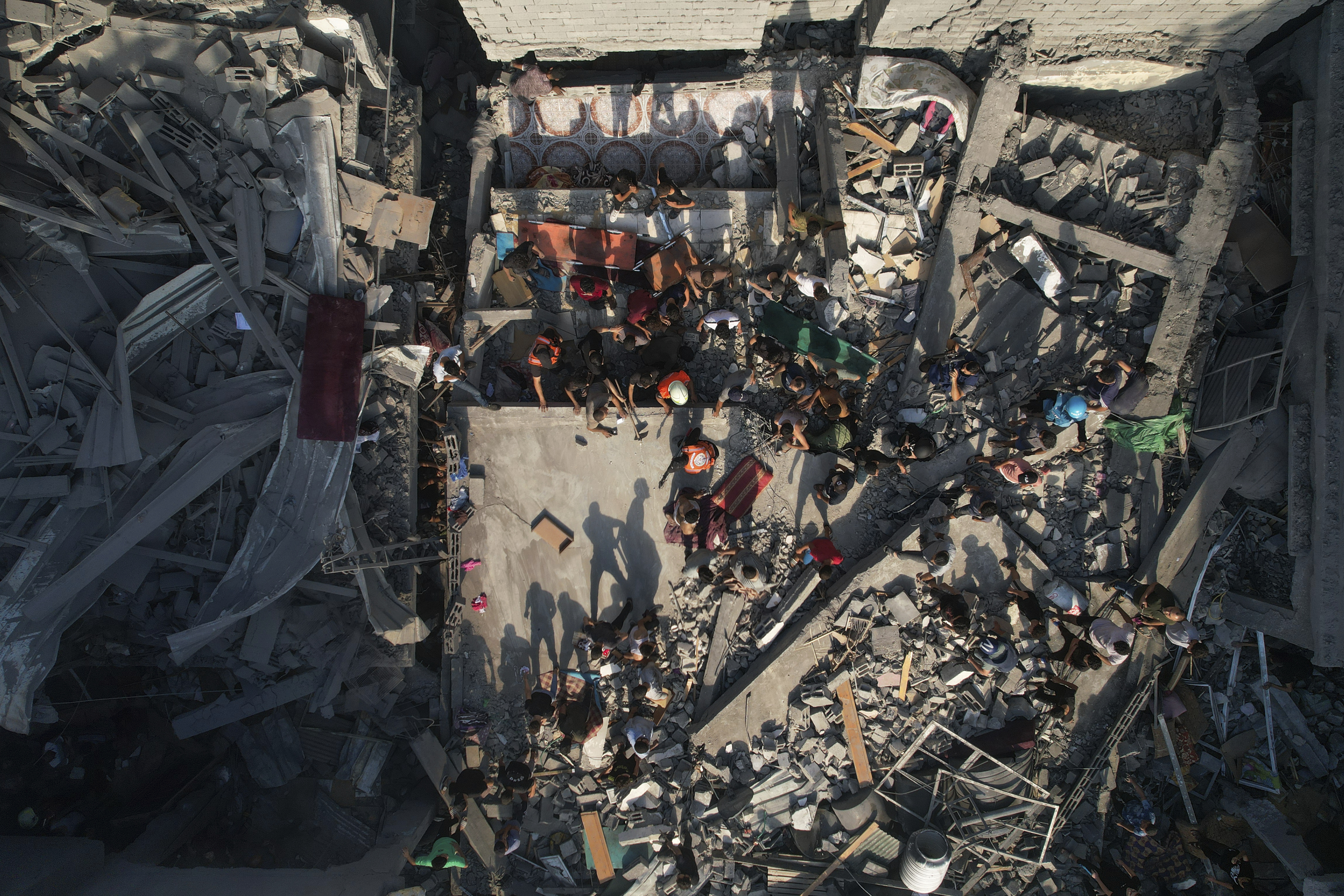 Thu., Oct. 12: Palestinians inspect the rubble of buildings hit by an Israeli airstrike at Al Shati Refugee Camp.
