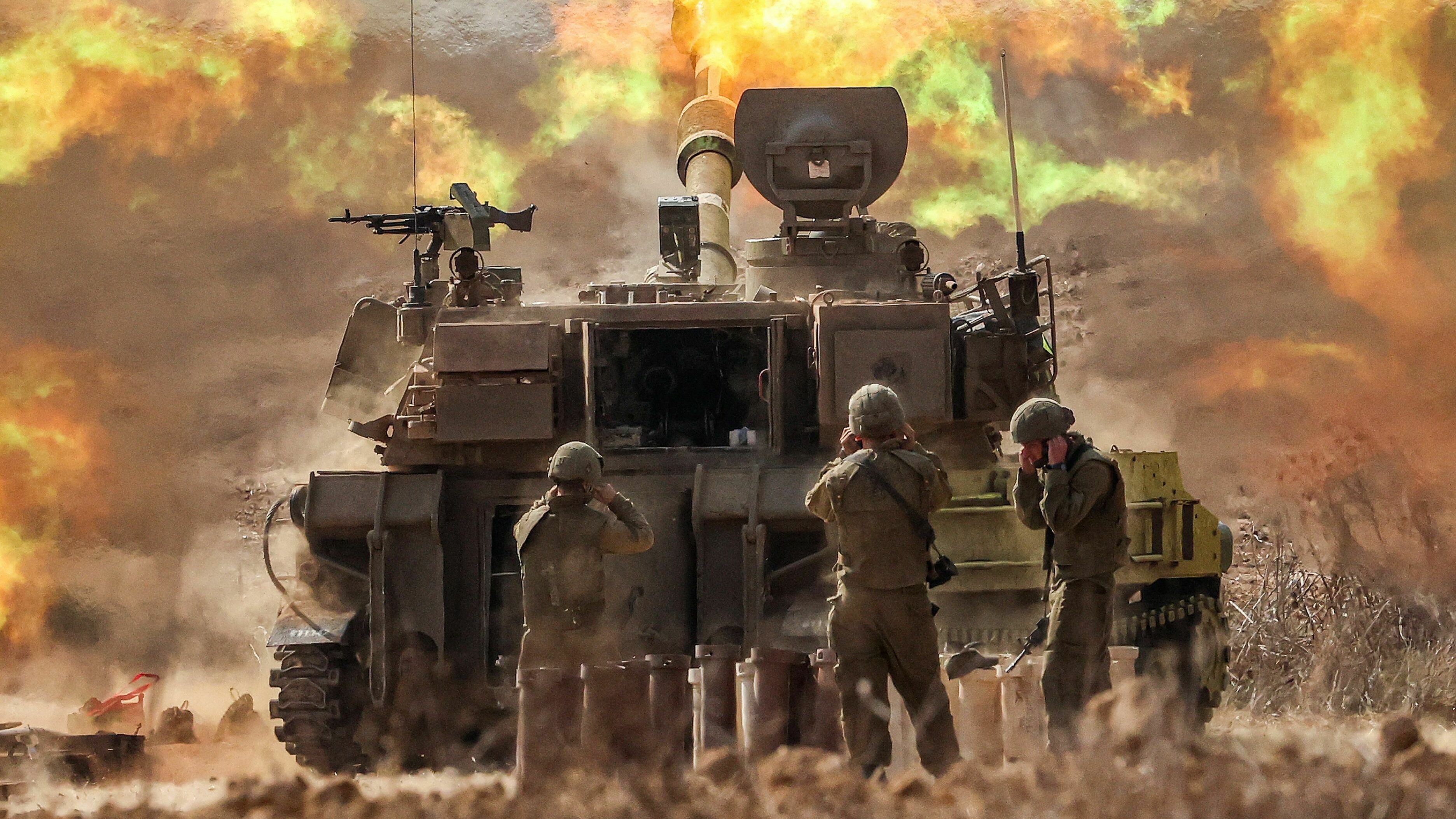 An Israeli army self-propelled howitzer fires rounds near the border with Gaza in southern Israel on Wednesday.