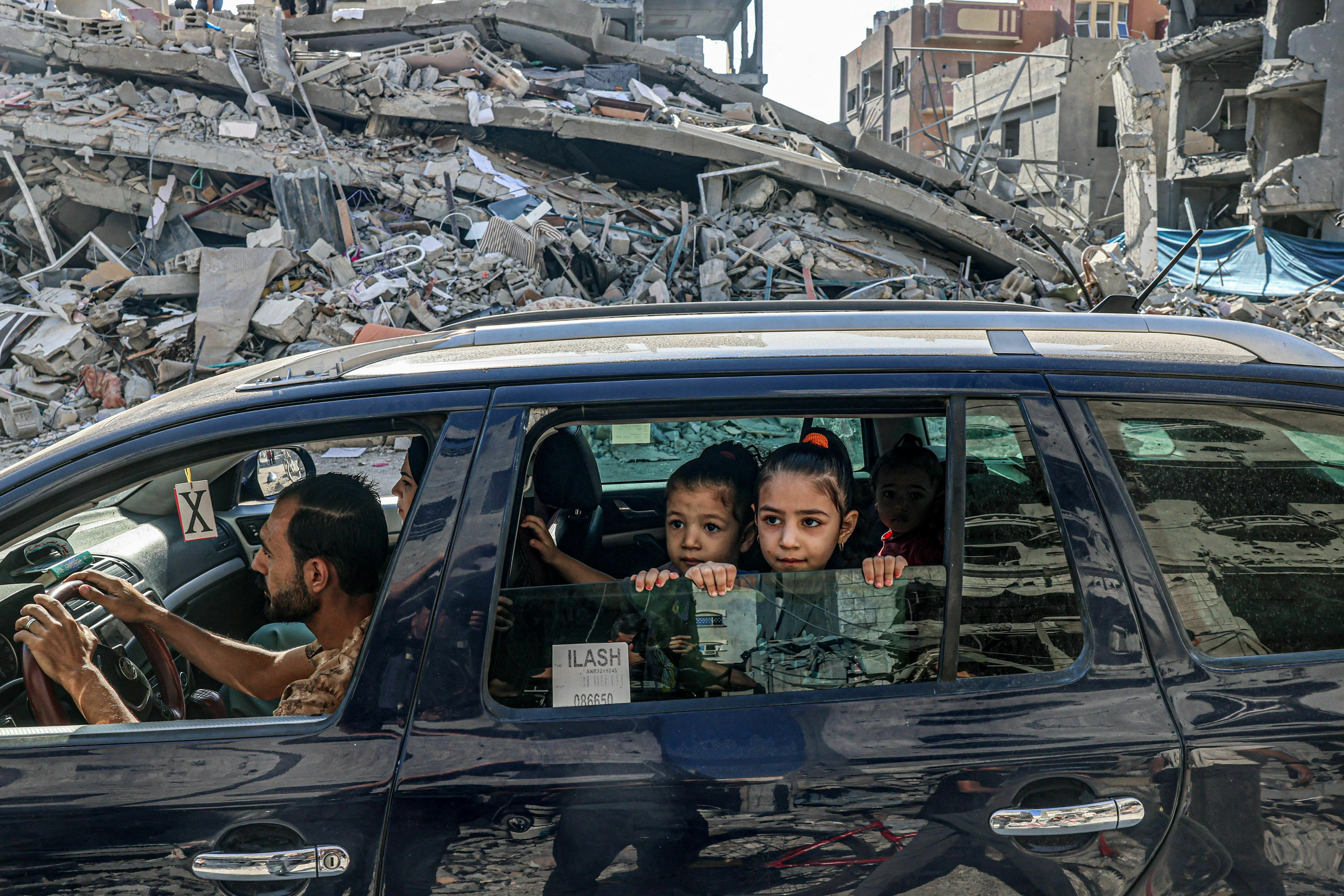 Thu., Oct. 12: Palestinians drive amid the rubble of buildings destroyed in an Israeli air strike in Rafah, on the southern Gaza Strip.
