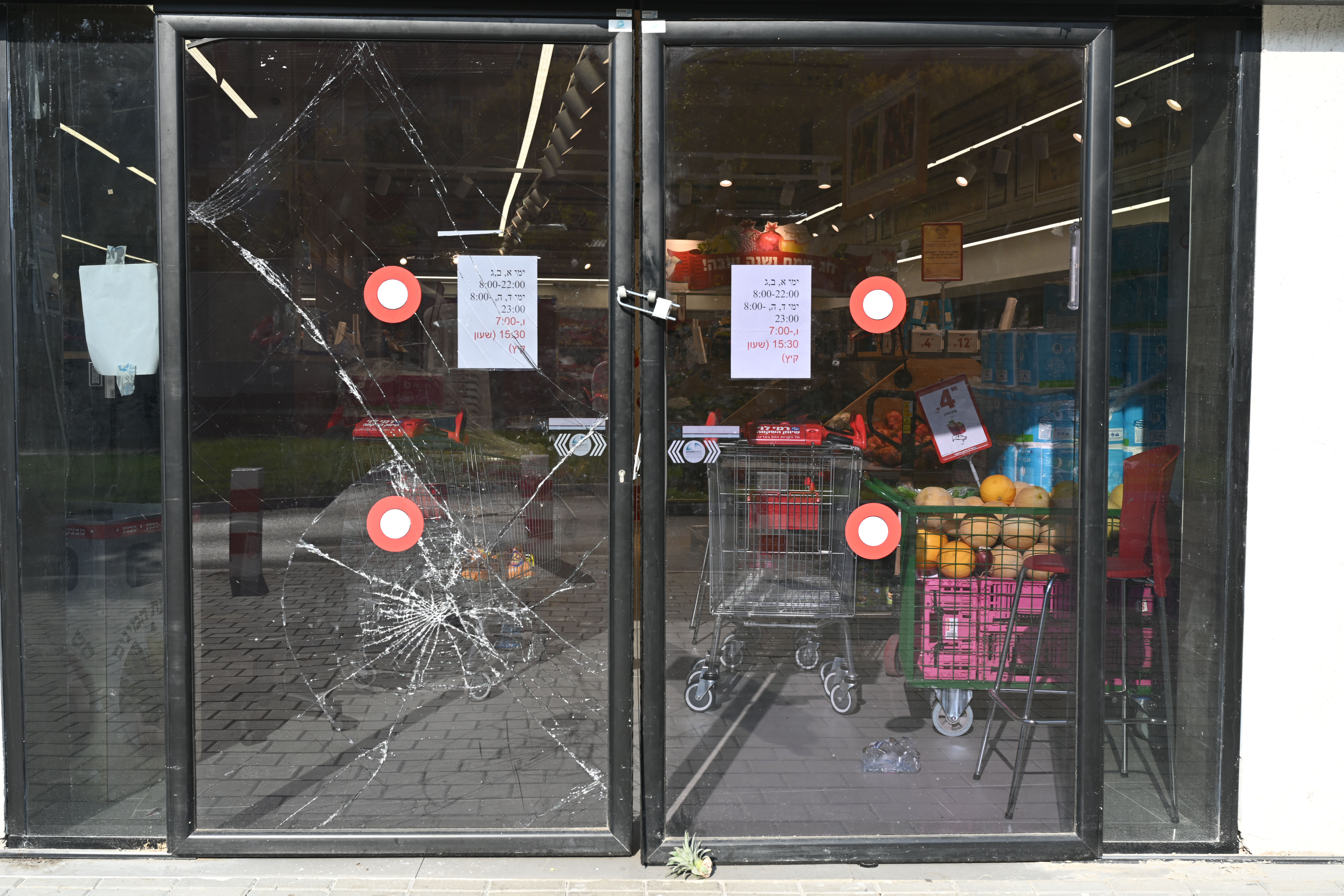 Left behind, in an assaulted Israeli town 8 Shattered glass at the entrance to a closed grocery store in Sderot, Israel.