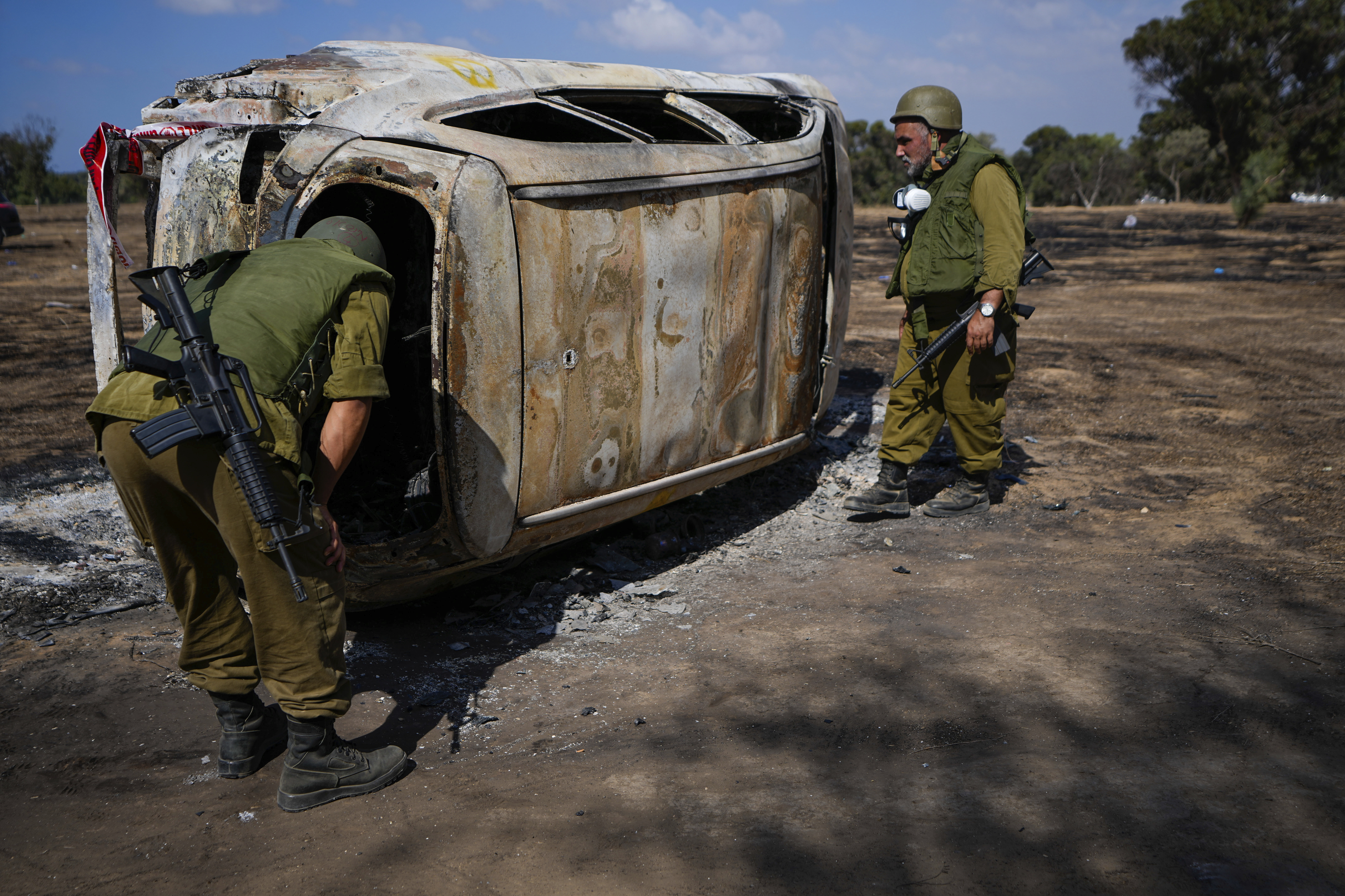 Fri., Oct. 13: Israeli soldiers inspect the site of a music festival near the border of the Gaza Strip in southern Israel.