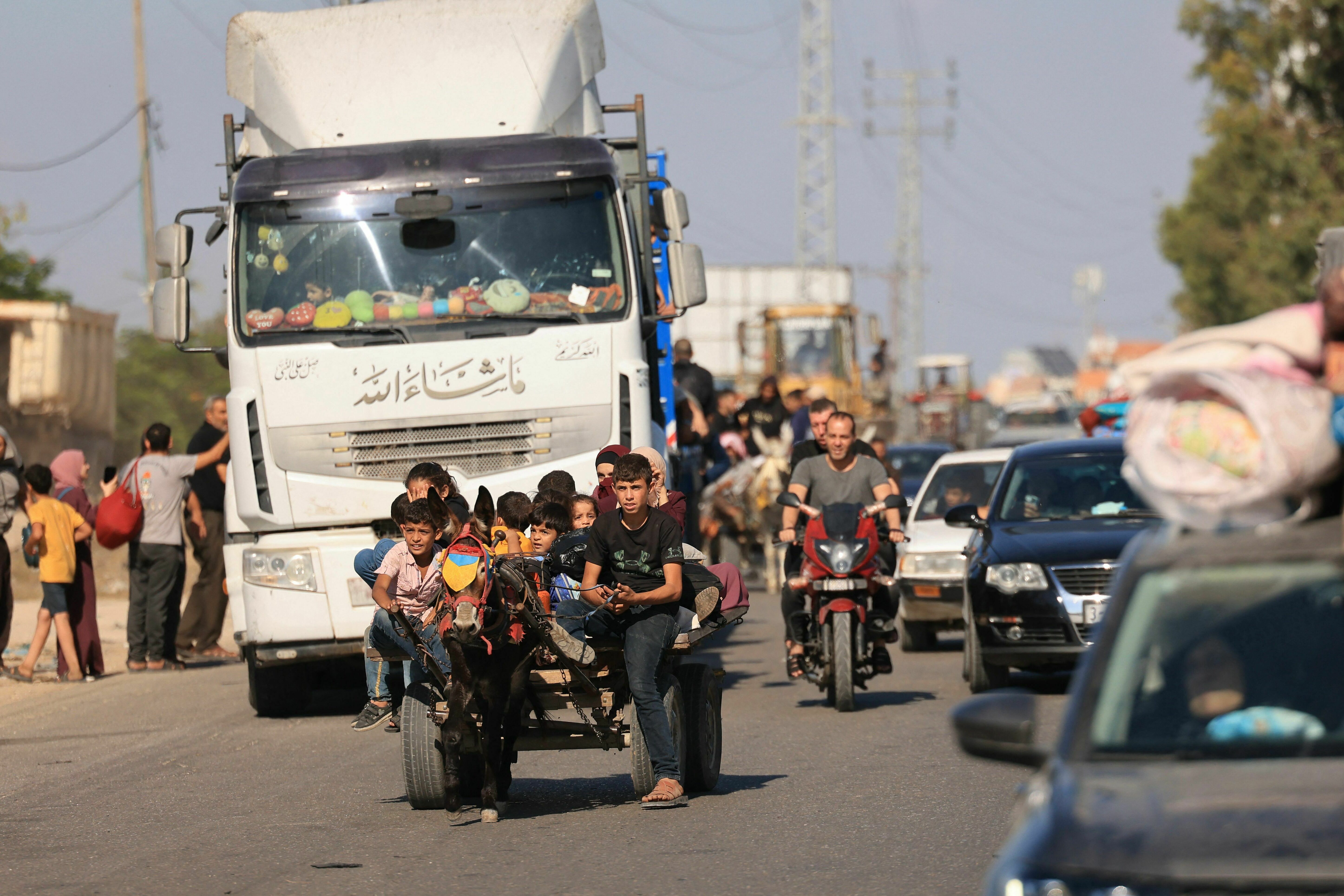 Fri., Oct. 13: A family riding a donkey drawn cart along with hundreds of other Palestinian carrying their belongings flee following the Israeli army's warning to leave their homes and move south before an expected ground offensive.
