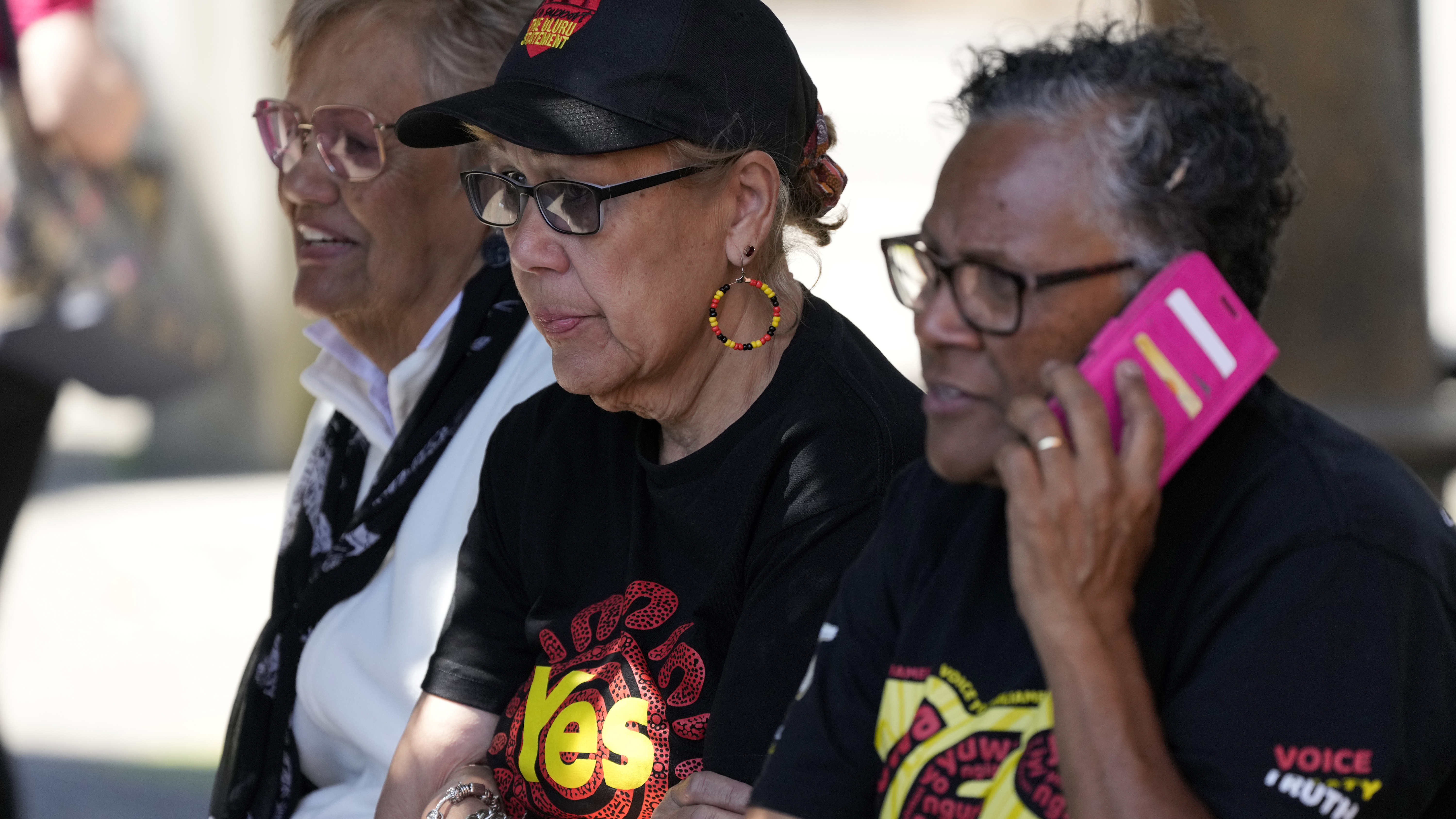 Indigenous women sit on a bench at a polling place in Sydney as Australians cast their final votes in the referendum to create an Indigenous advocacy committee to Parliament.