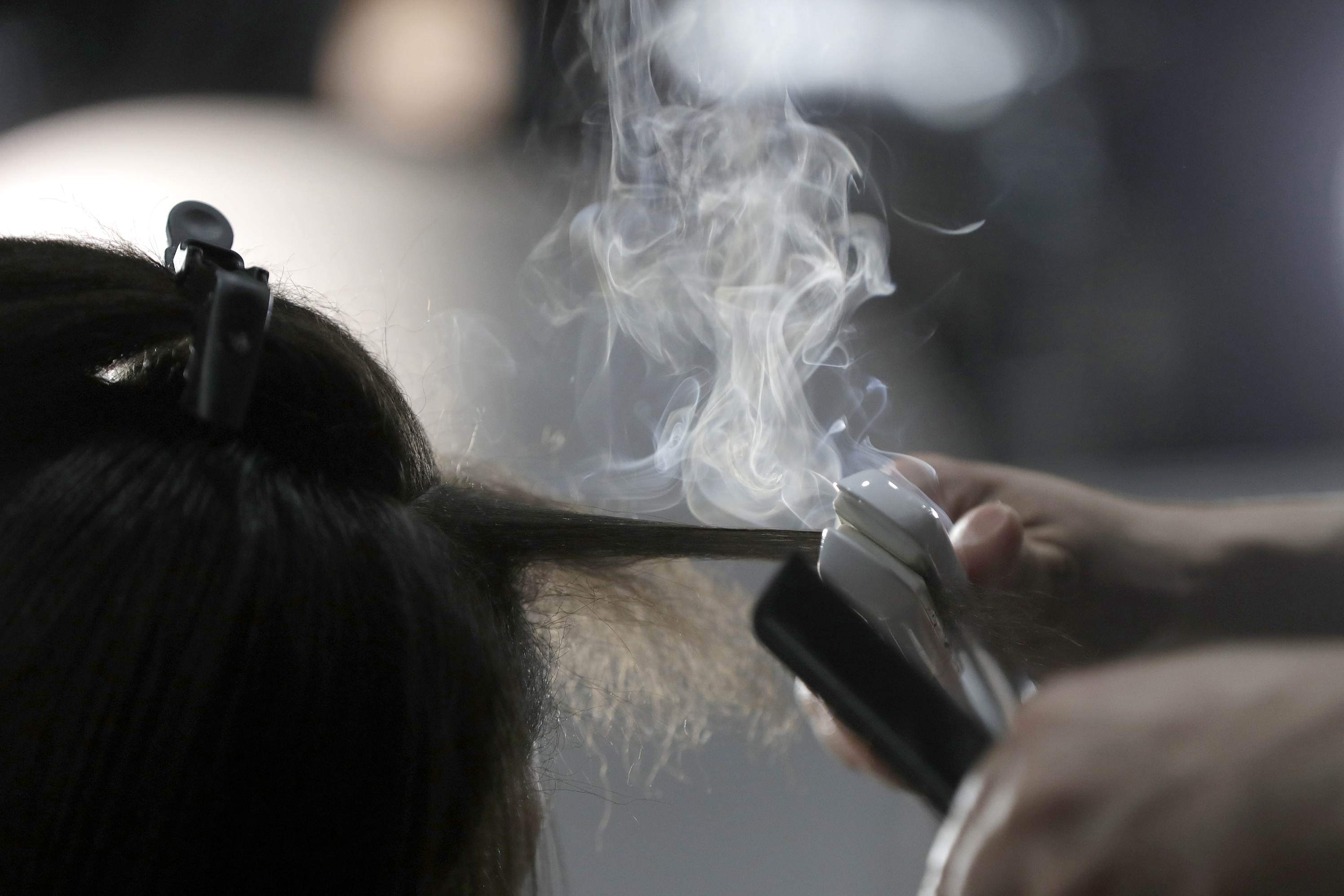 Steam rises as a hair stylist works on a model prior to a show displaying the Tom Ford collection during Fashion Week on Feb. 6, 2019, in New York. People of color in the industry trace bias and discrimination in predominantly white salons to the sidelining of formal education focused on Black hair.