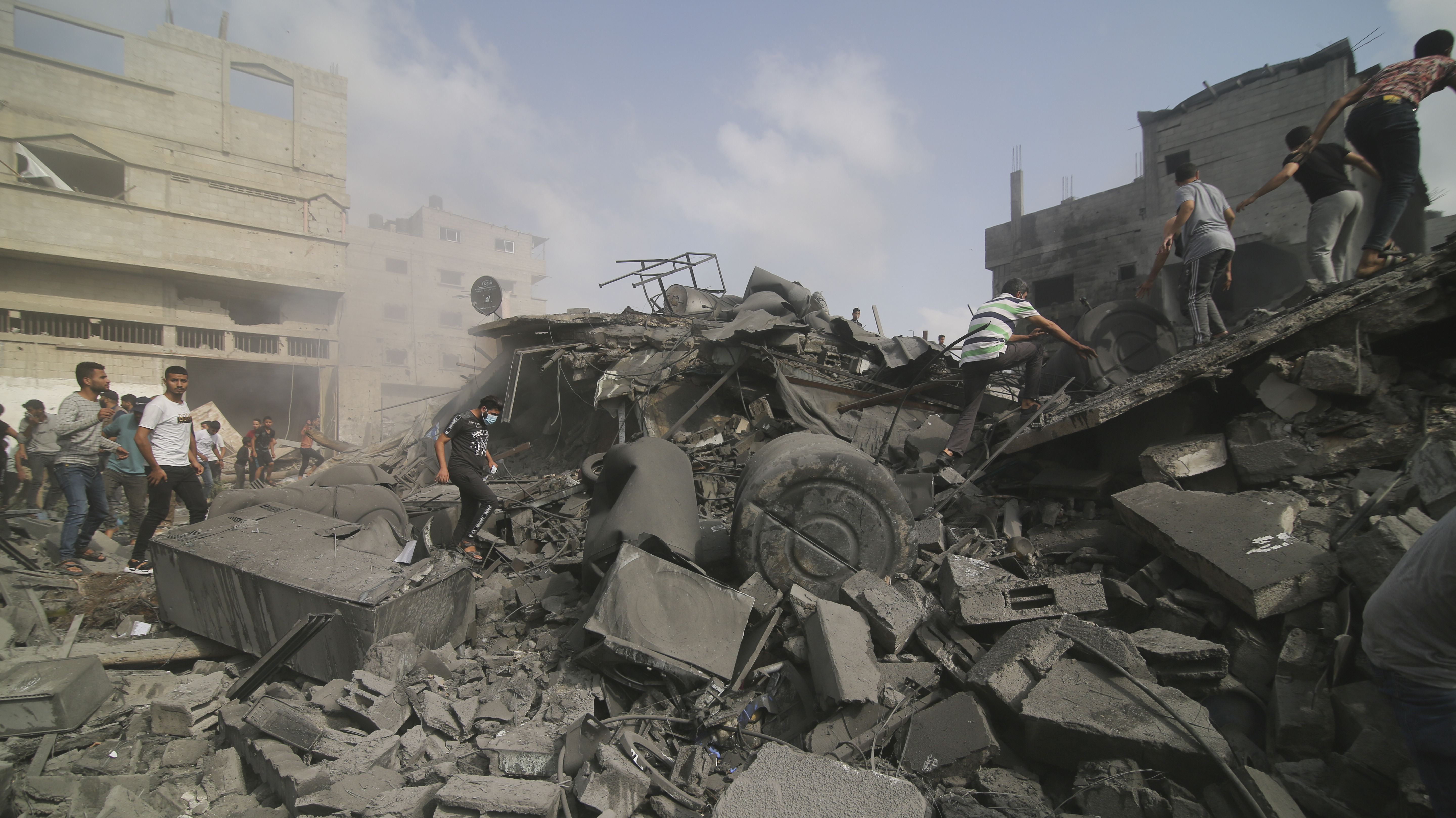 Palestinians look for survivors in buildings destroyed in the Israeli bombardment of the Gaza Strip in Rafah on Sunday.
