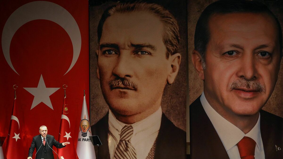 Turkish President Recep Tayyip Erdogan addresses a meeting of provincial election officials in front of a giant portrait of him and one of Mustafa Kemal Ataturk, the founder of modern Turkey, in Ankara on January 29, 2019.