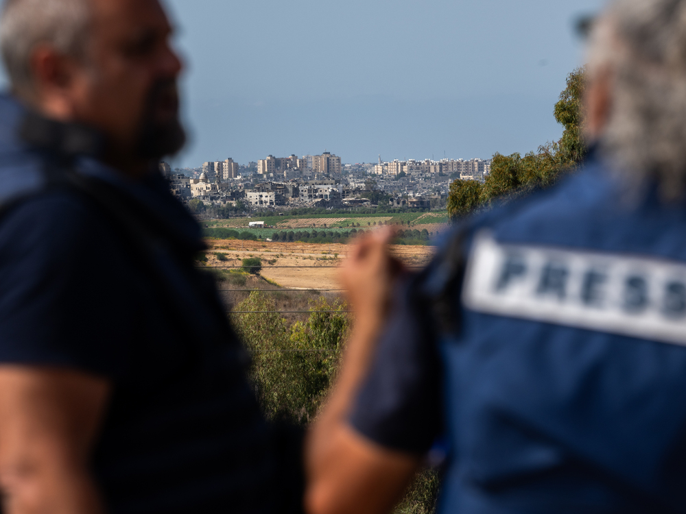 Members of the press wait on an overlook in Sderot, Israel, to report on the fighting in Gaza on Oct. 21. (Getty Images)