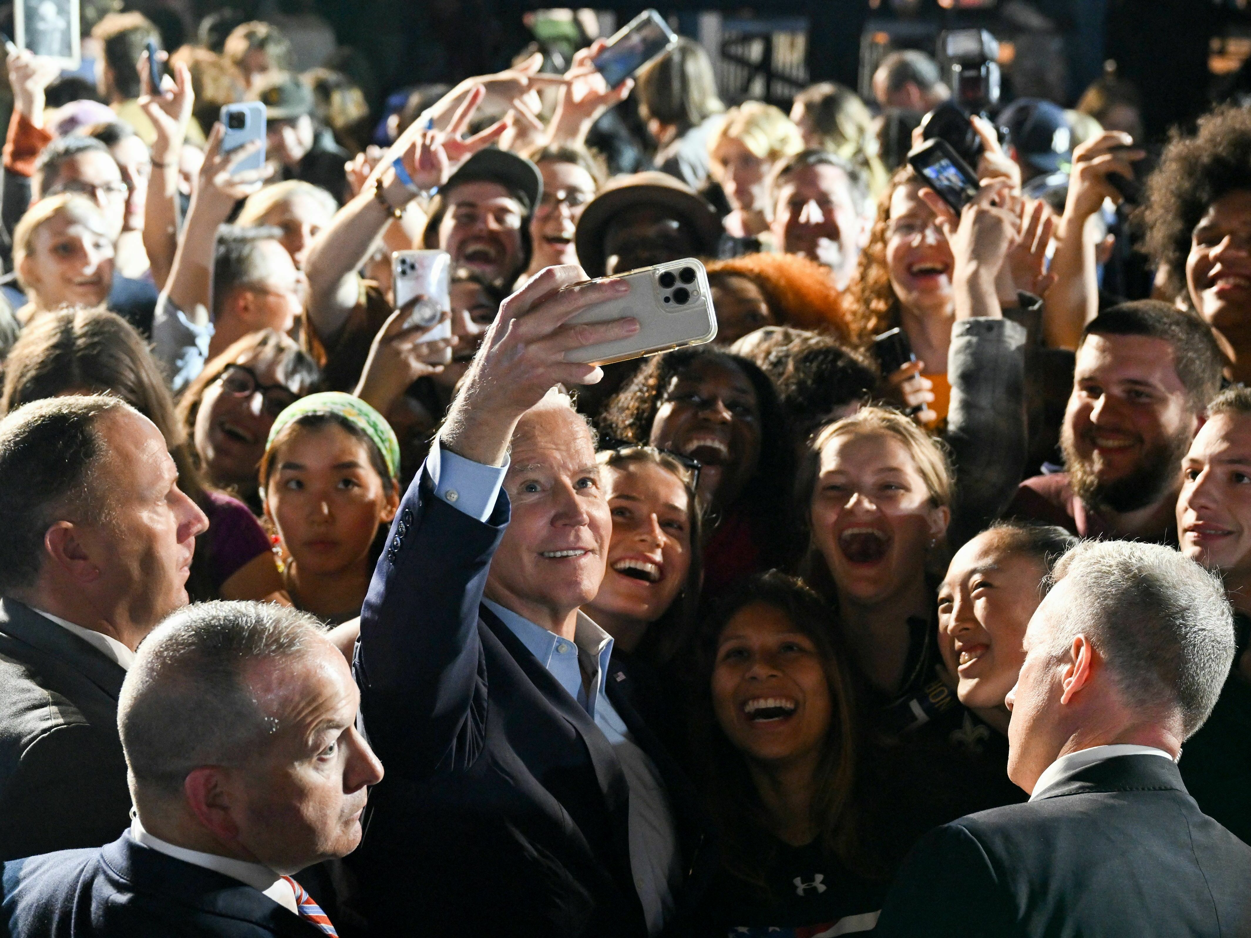 President Biden takes a selfie with supporters during a rally in New York ahead of the 2022 midterm elections. (AFP via Getty Images)