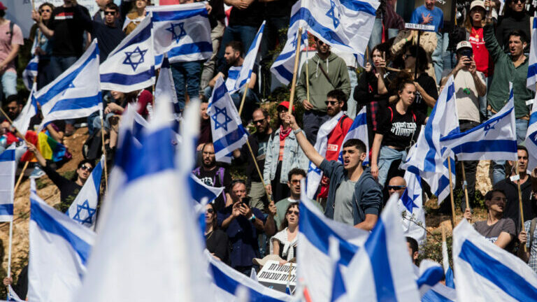 Protestors wave flags as thousands of Israelis attend a rally against Israeli Government's judicial overhaul plan in Jerusalem, Israel. (Getty Images)