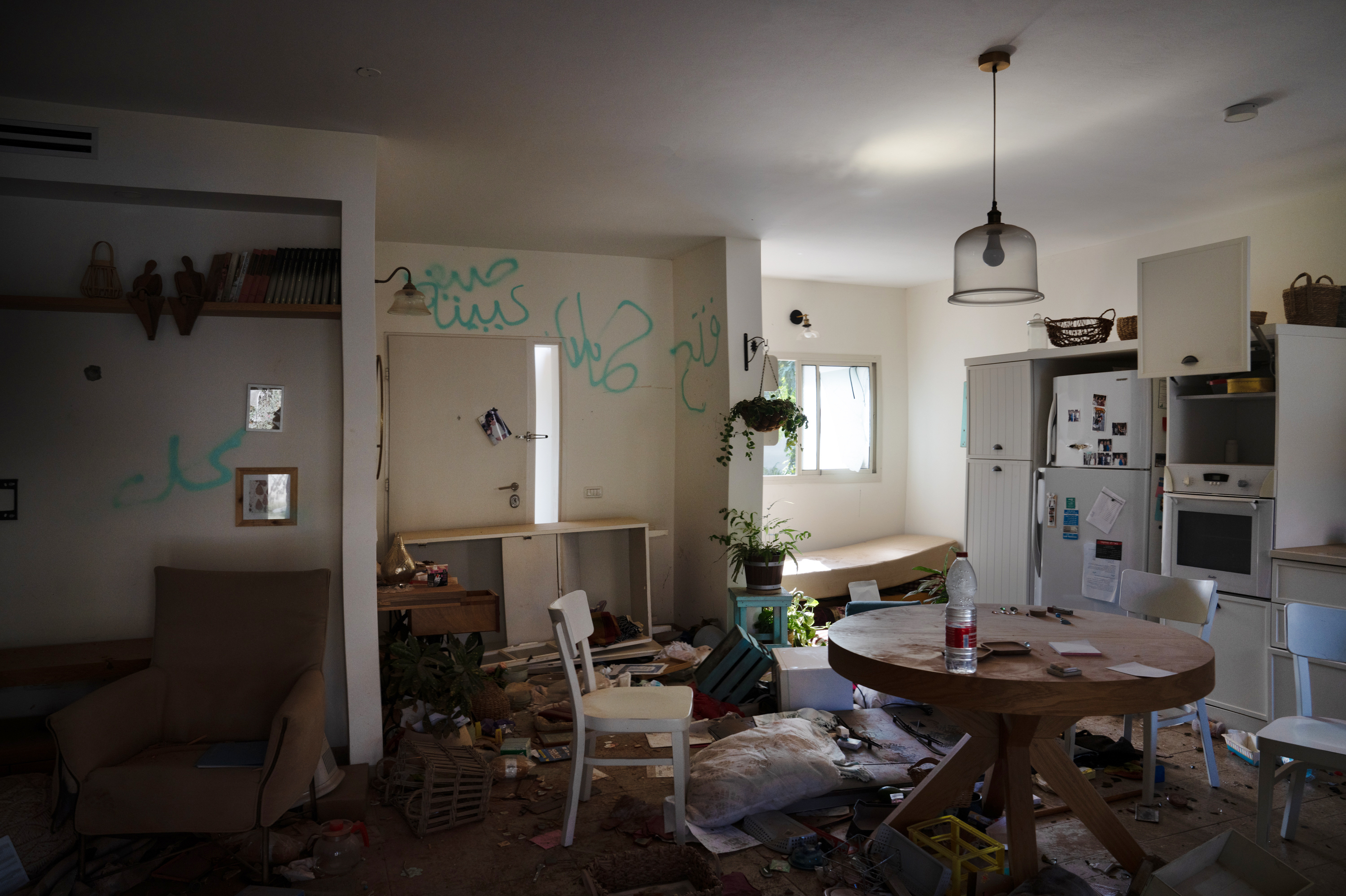 A destroyed home is seen in Kibbutz Be'eri, a community that was attacked by Hamas militants almost three weeks ago near the Israeli-Gaza border. Graffiti left by the attackers can be seen on the walls of the home. (NPR)
