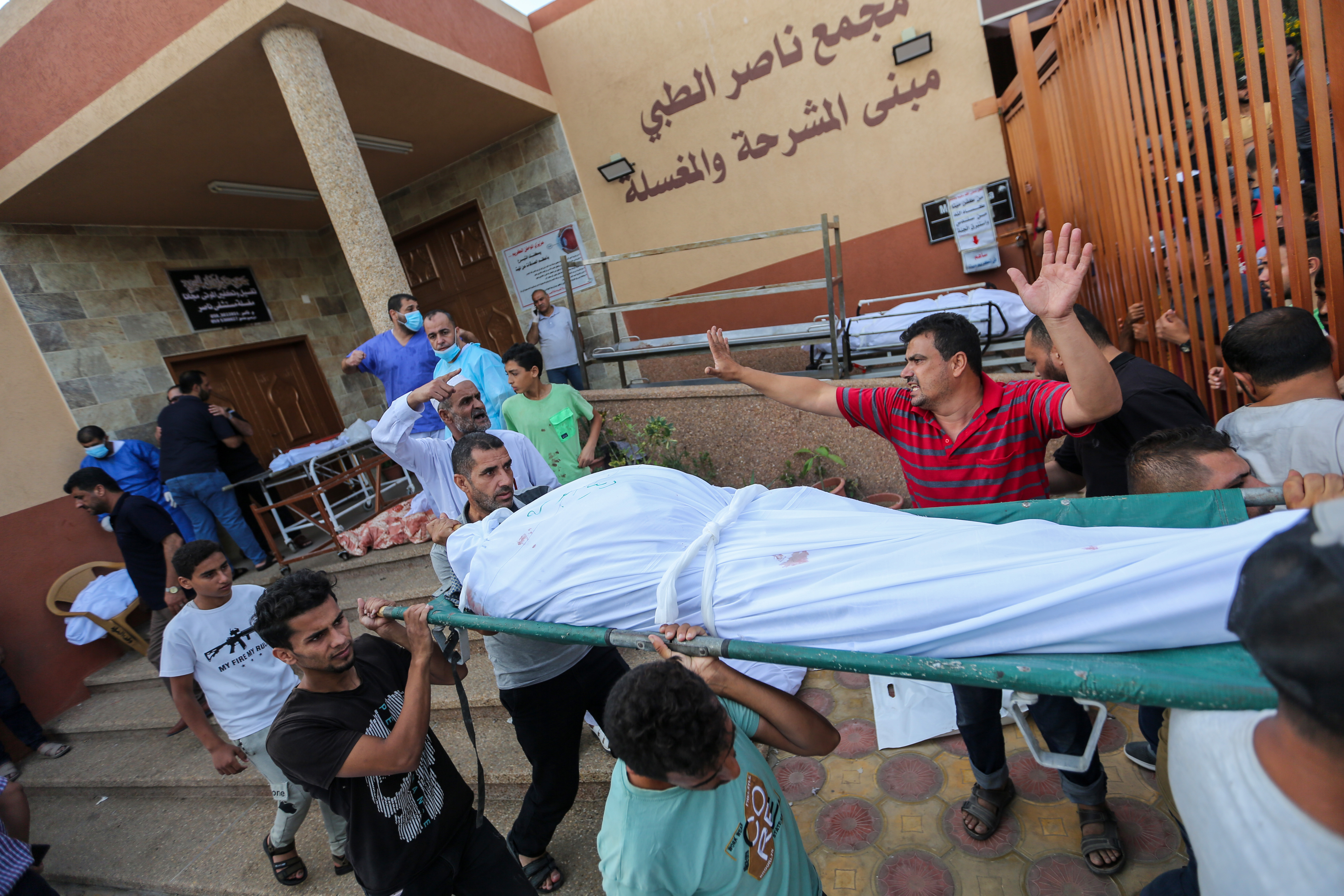 On Friday in the Gaza city of Khan Younis, people collect the bodies of Palestinians killed in airstrikes. (Getty Images)