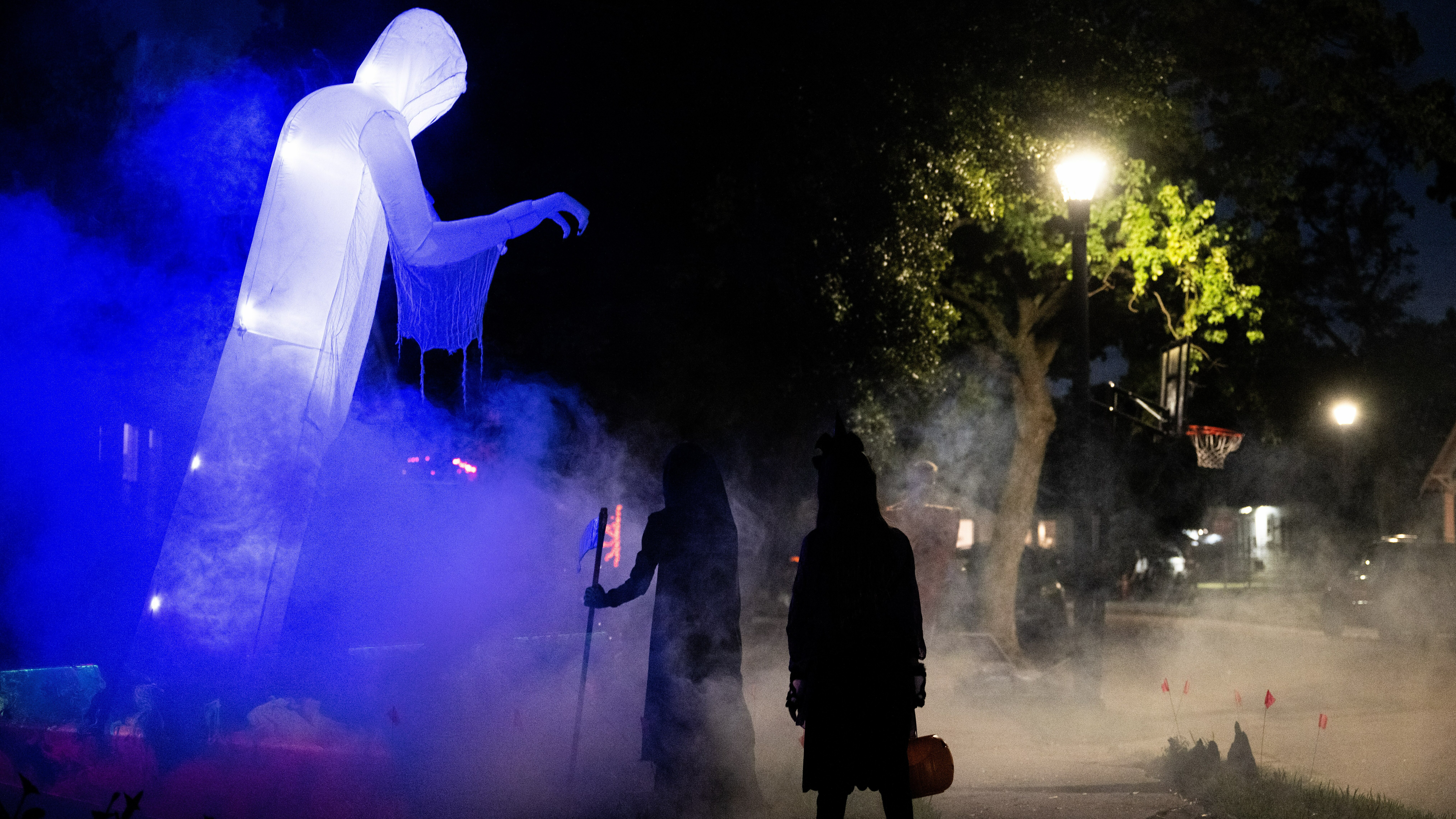 Children walk past Halloween decorations last year. In several U.S. towns, it