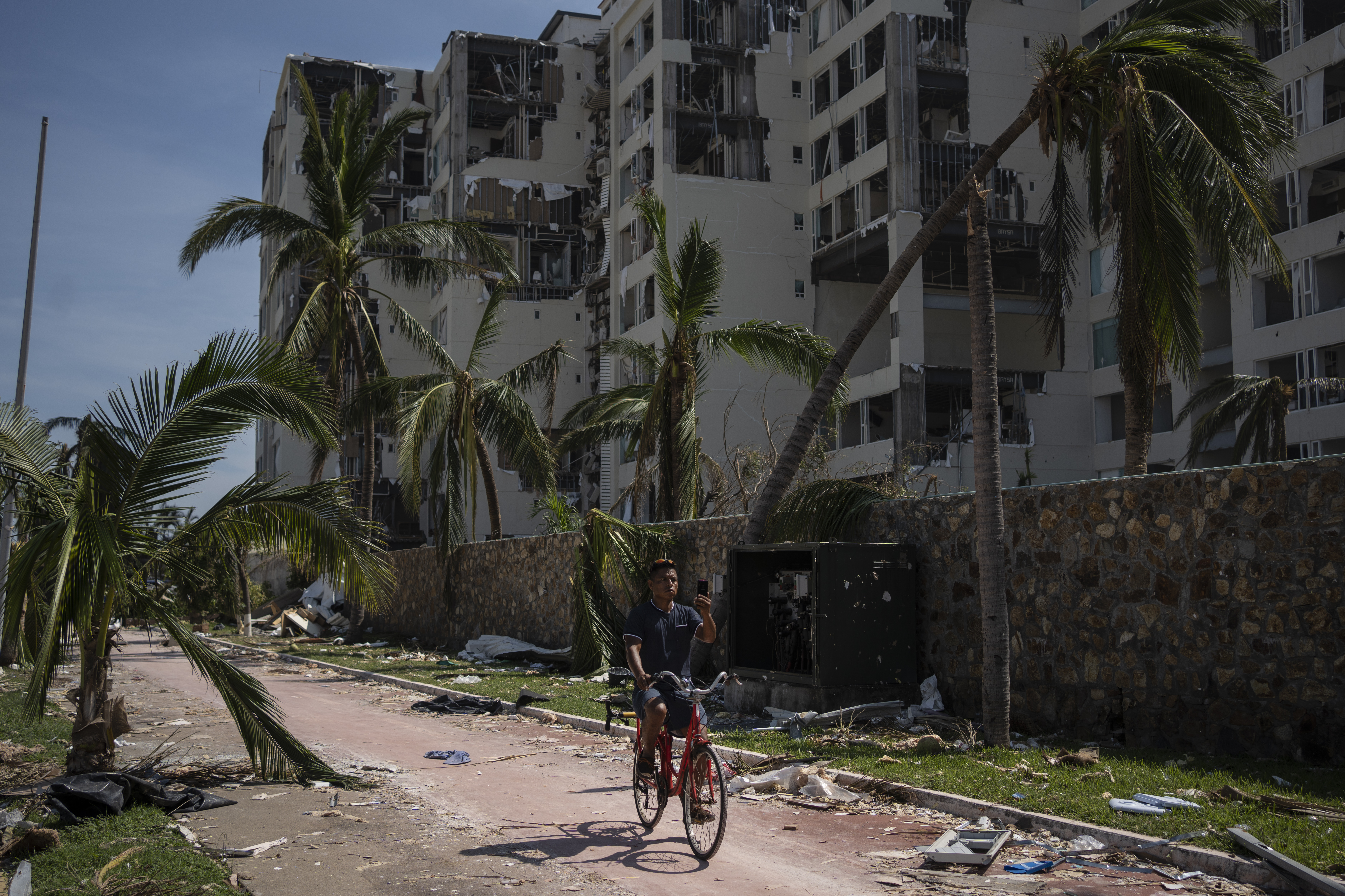 Oct. 29: A man rides at a damaged zone in the aftermath of Hurricane Otis in Acapulco, Mexico.