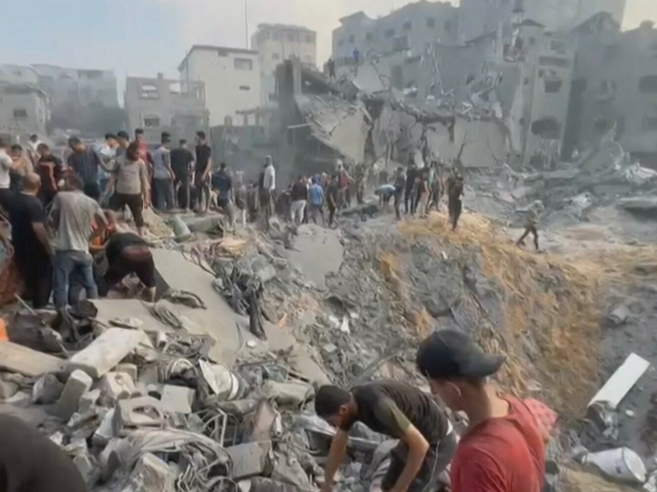 Palestinians dig through rubble looking for survivors in a crater following a strike on a refugee camp in Jabalia on the northern Gaza Strip, on Tuesday, Oct. 31, 2023. (AFP via Getty Images)