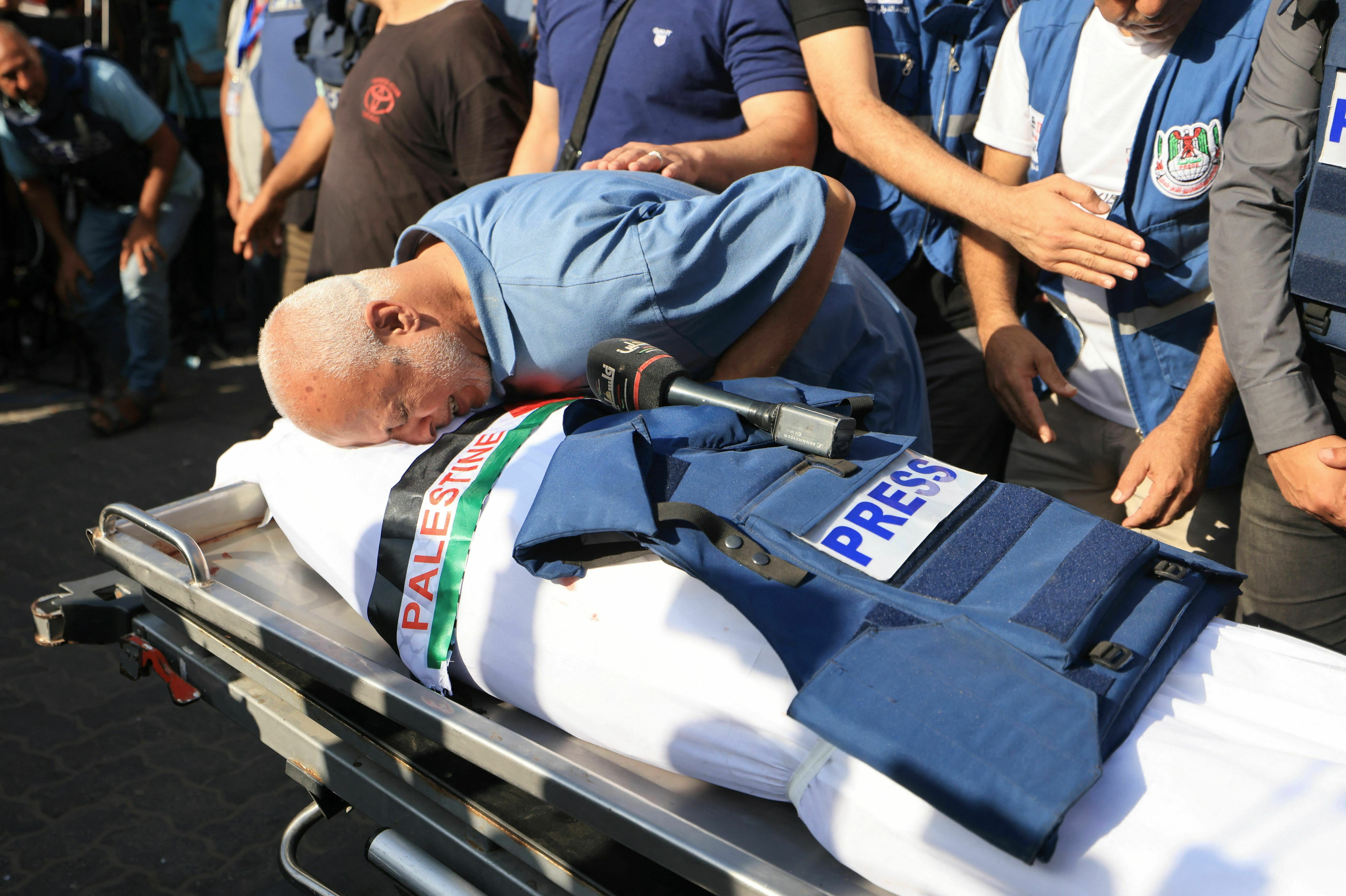 A relative bids farewell during the funeral of Palestine TV journalist Mohamed Abu Hatab and 11 family members the day after they were killed when their home was hit in the Israeli bombardment of Khan Yunis, in the southern Gaza Strip on Friday amid the ongoing battles between Israel and the Palestinian group Hamas.
