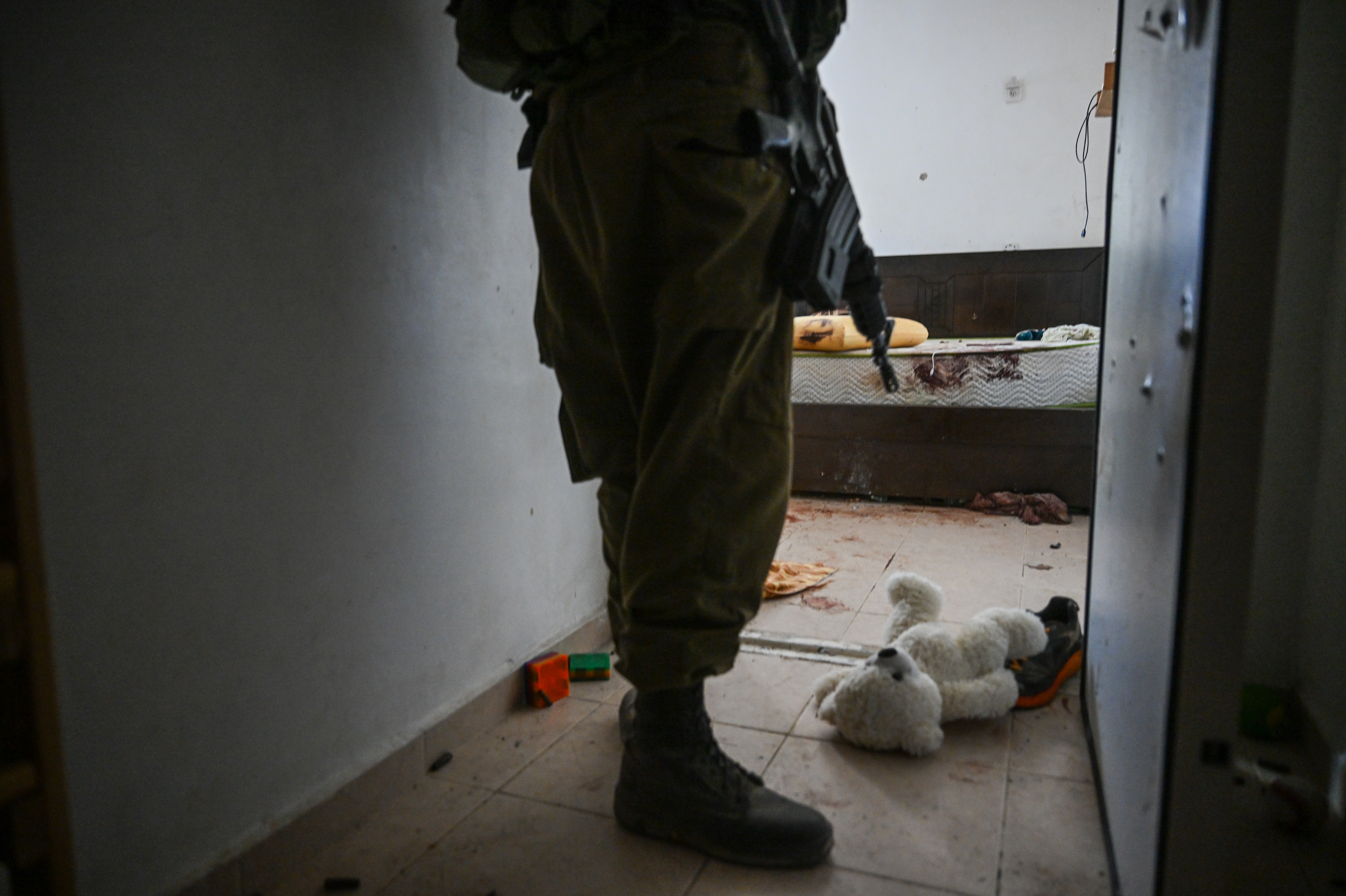 A teddy bear is seen left on the ground near the bomb shelter of a kibbutz home attacked by Hamas on Oct. 7, near the border with Gaza, on Wednesday in Holit, Israel.