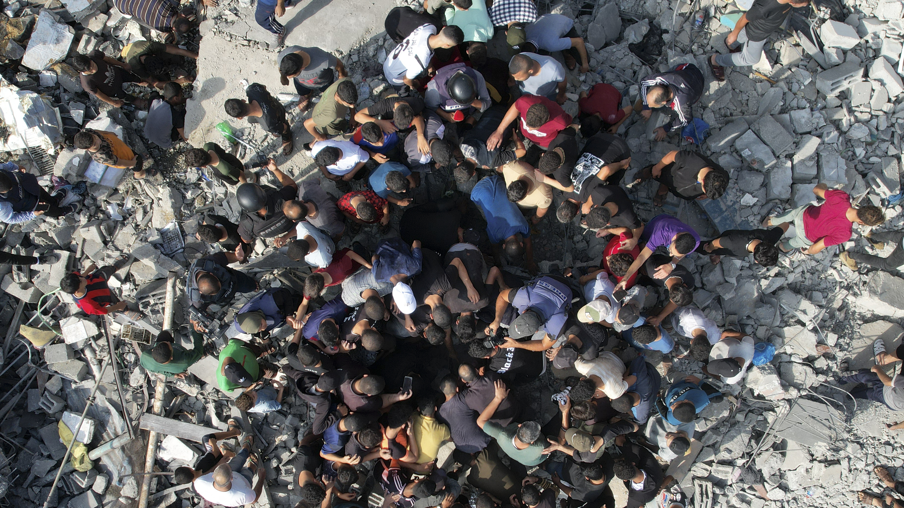 Palestinians look for survivors of an Israeli bombardment in the Maghazi refugee camp in the Gaza Strip on Sunday.