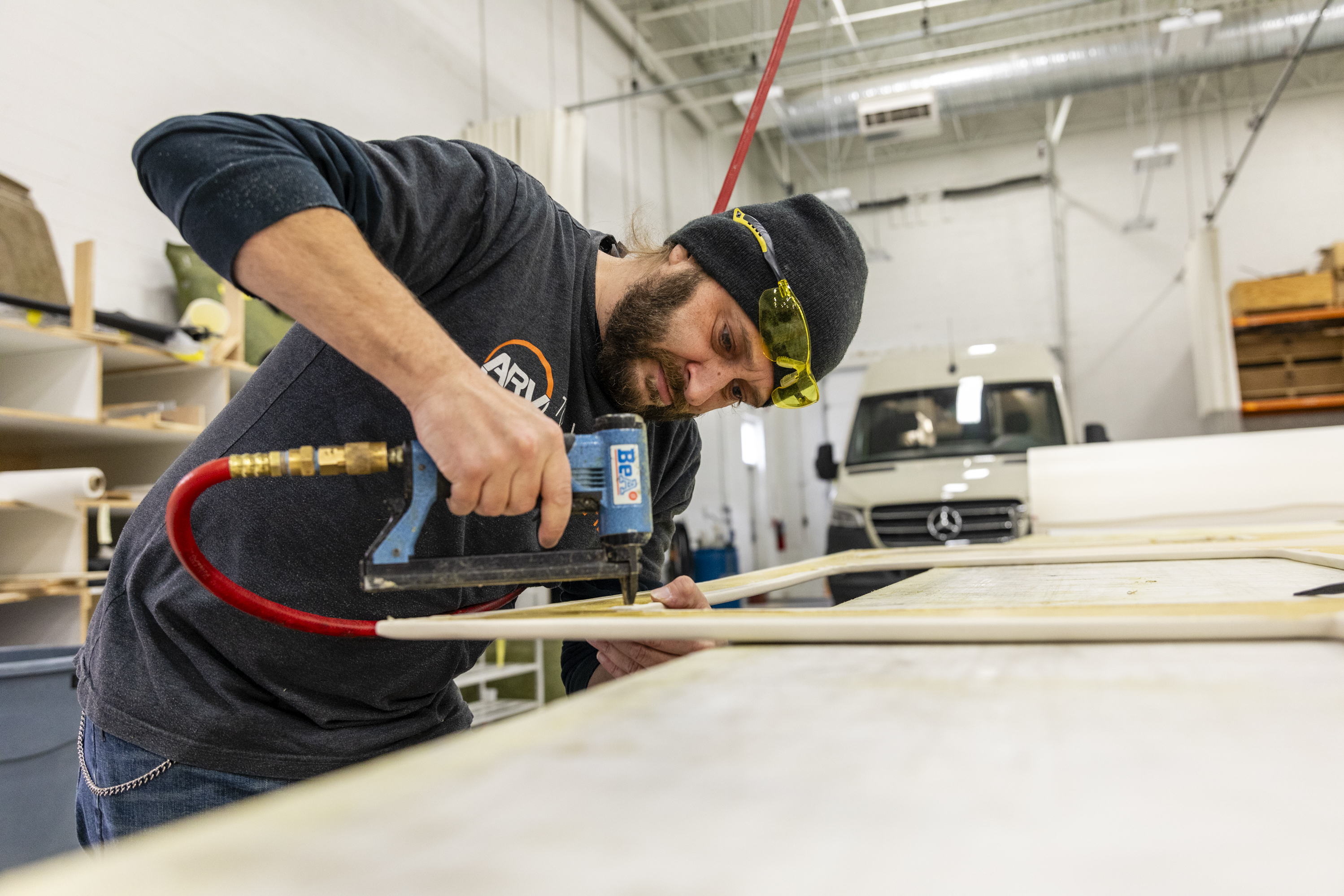 Bill Kowalcic works on wall panels in the finishing department at Advanced RV. After the company went to a four-day workweek, his team figured out how to cut time without cutting corners. (Amber N. Ford for NPR)