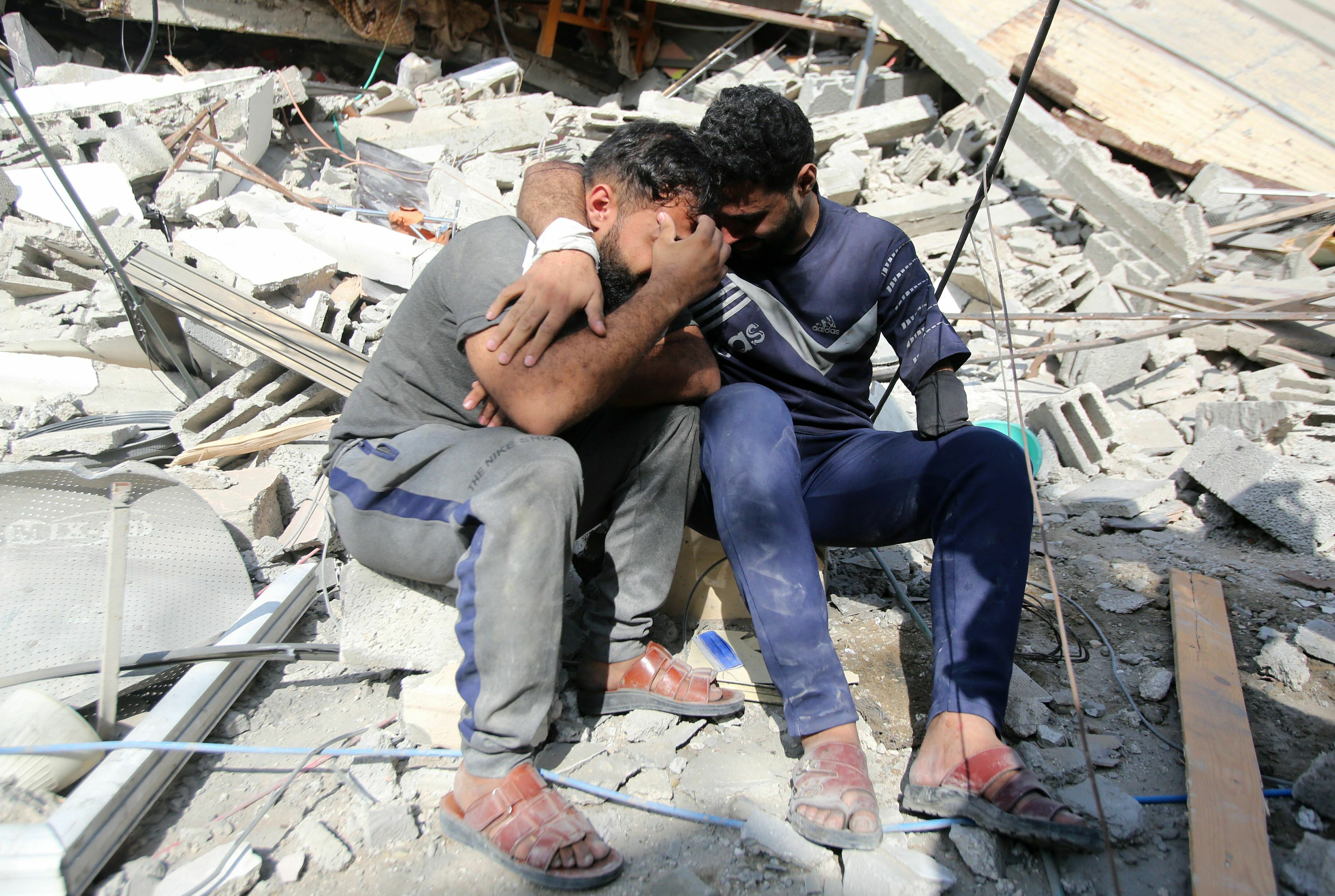 Mon., Nov. 6: Palestinians mourn as they sit on the rubble of a building in Gaza City's Shati refugee camp, amid ongoing battles between Israel and the Palestinian Hamas movement.