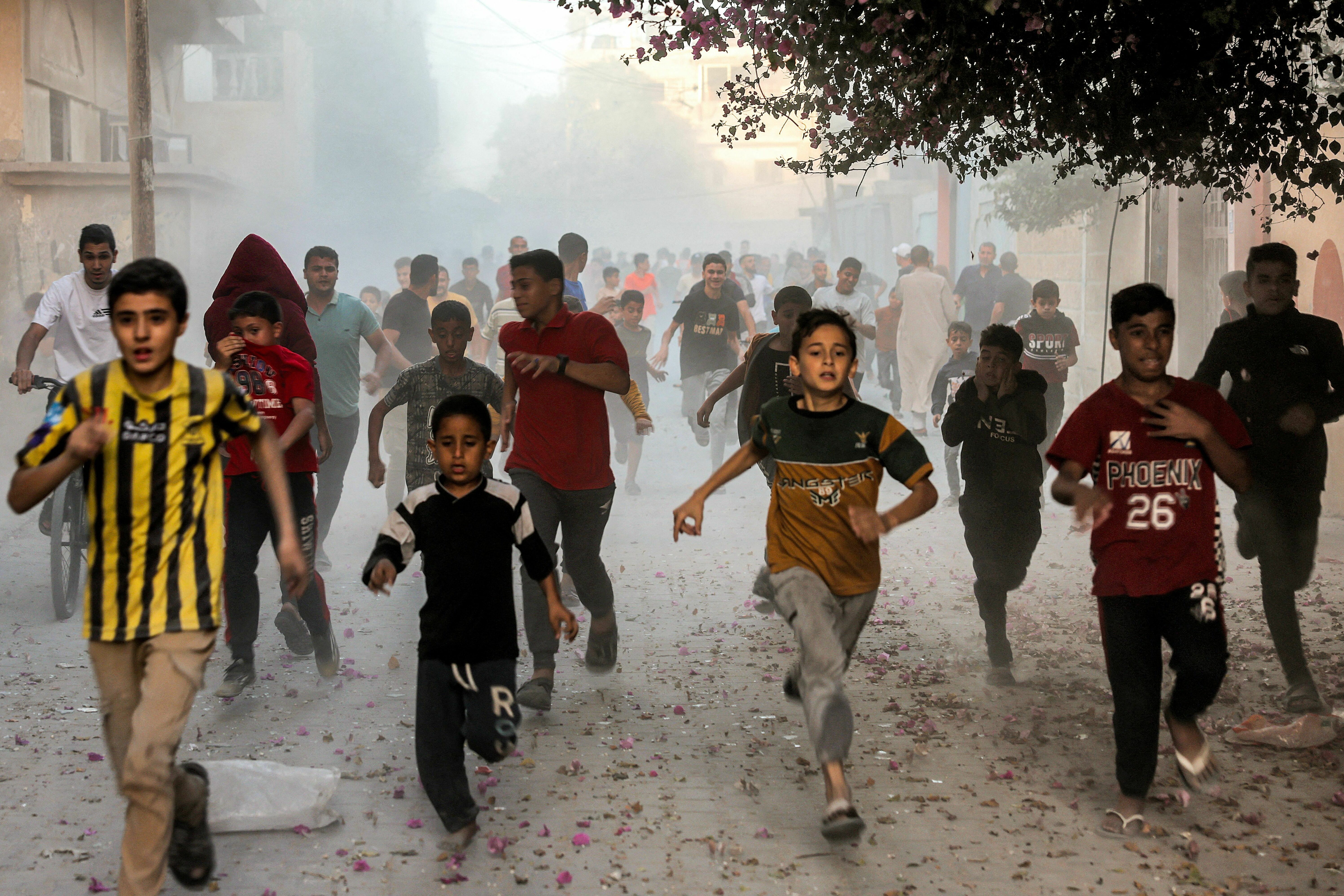 Mon., Nov. 6: Palestinians run as they flee from Israeli bombardment in Rafah in the southern Gaza Strip.
