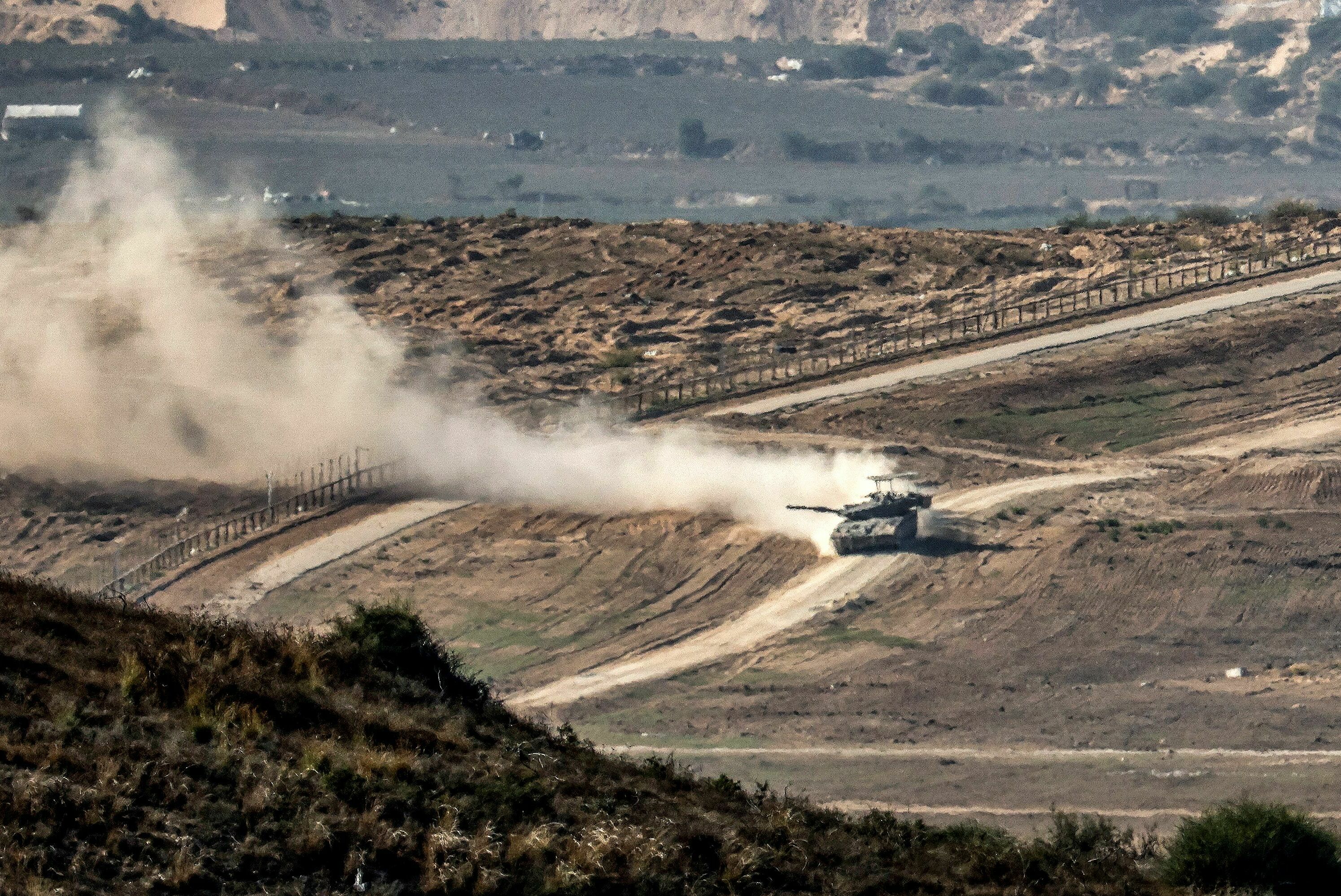 Weds., Nov. 8: An Israeli army battle tank moves at a position near a barbed wire fence along the border with the Gaza Strip and southern Israel.