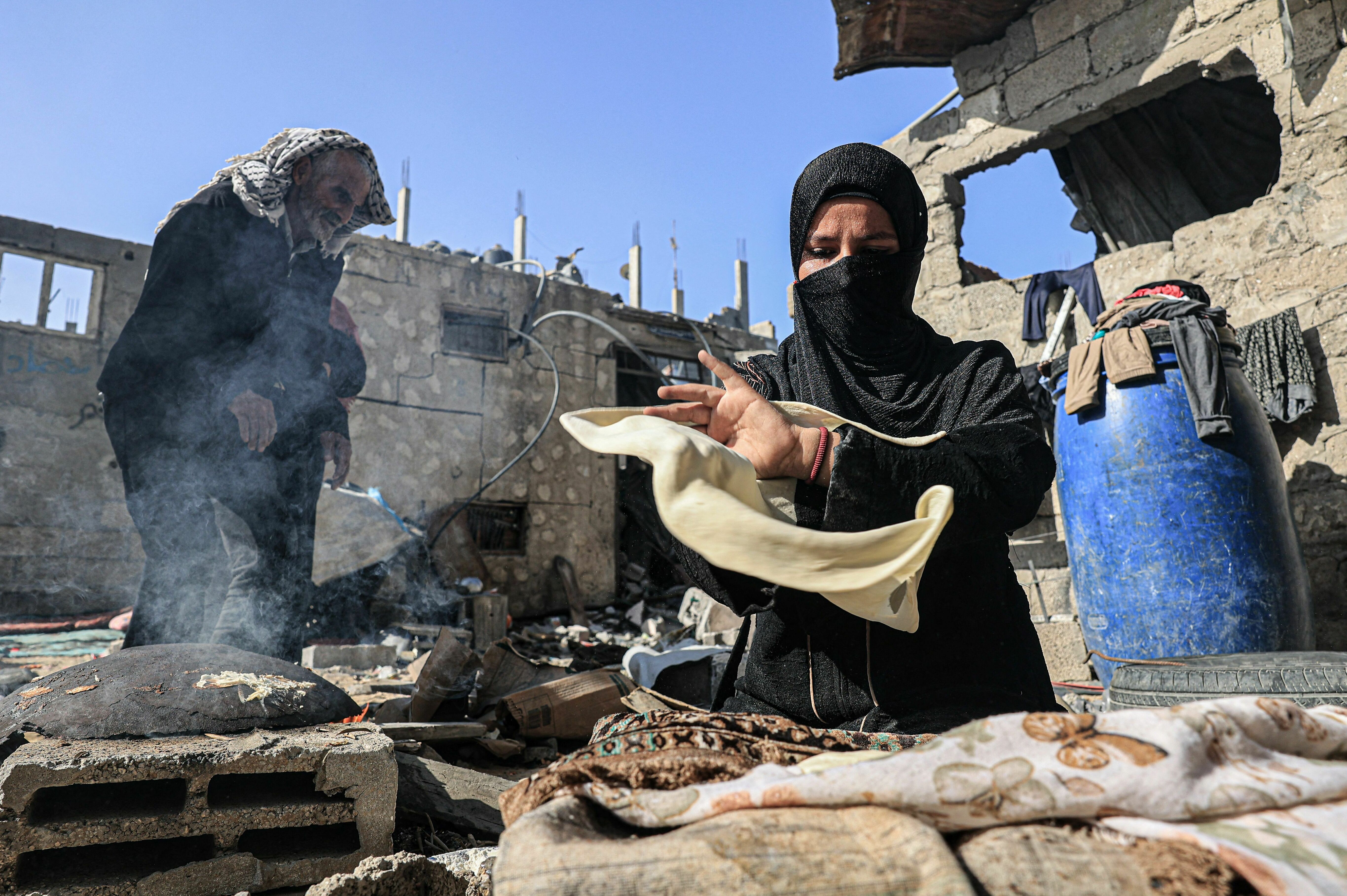 Tues., Nov. 7: Amal al-Robayaa makes bread with flour found by her sister-in-law Nesrine, amid the ruins of the family home destroyed in an Israeli strike in Rafah in the southern Gaza Strip. Robayaa says the apartment she lived in was destroyed by an Israeli bombardment. She sleeps with other family members in a U.N. school in Rafah but returns to her home in the morning to find food and water.