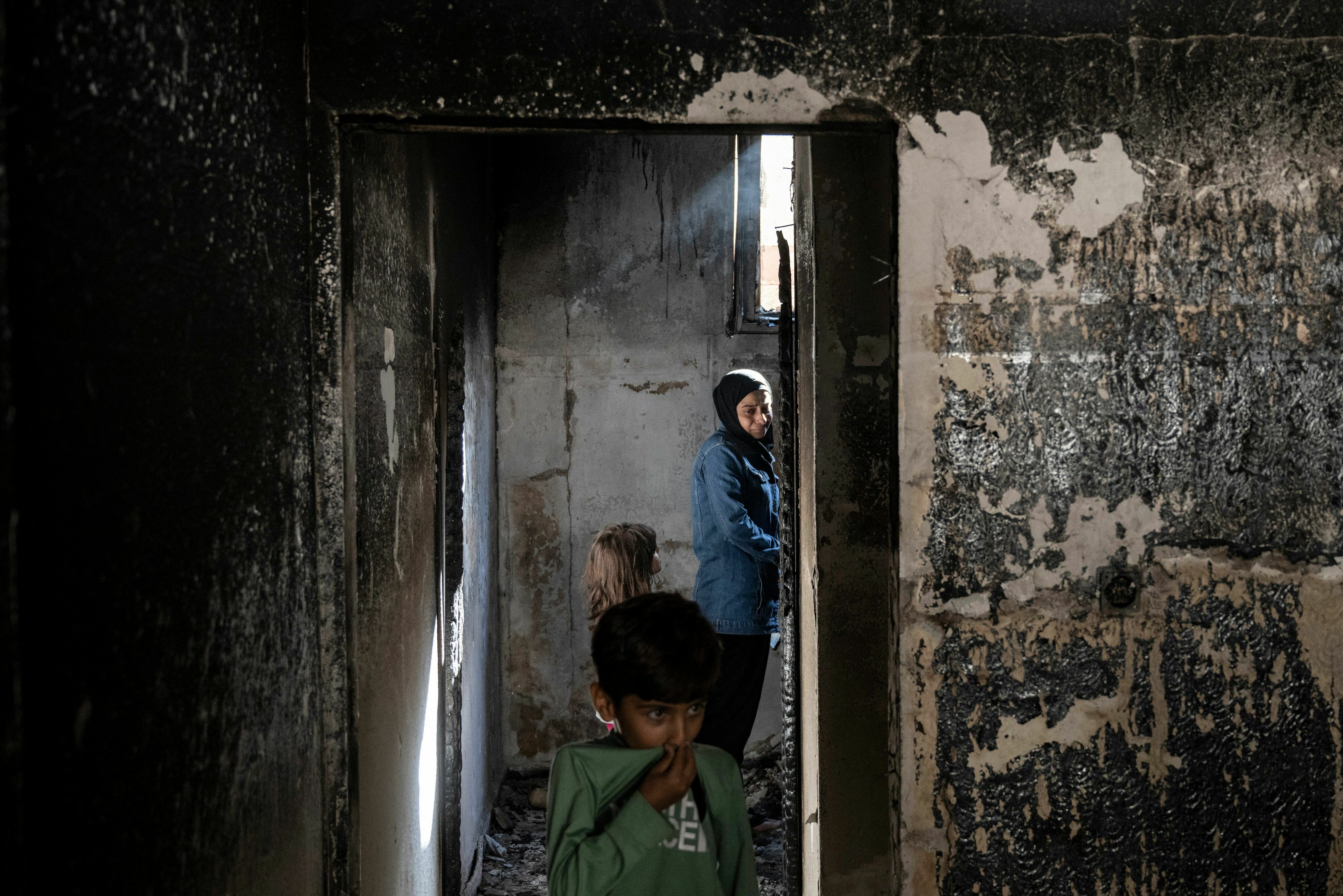 Fri., Nov. 10: A woman an children stand inside a house damaged in an Israeli raid followed by clashes with Palestinians, in the occupied West Bank Jenin refugee camp.