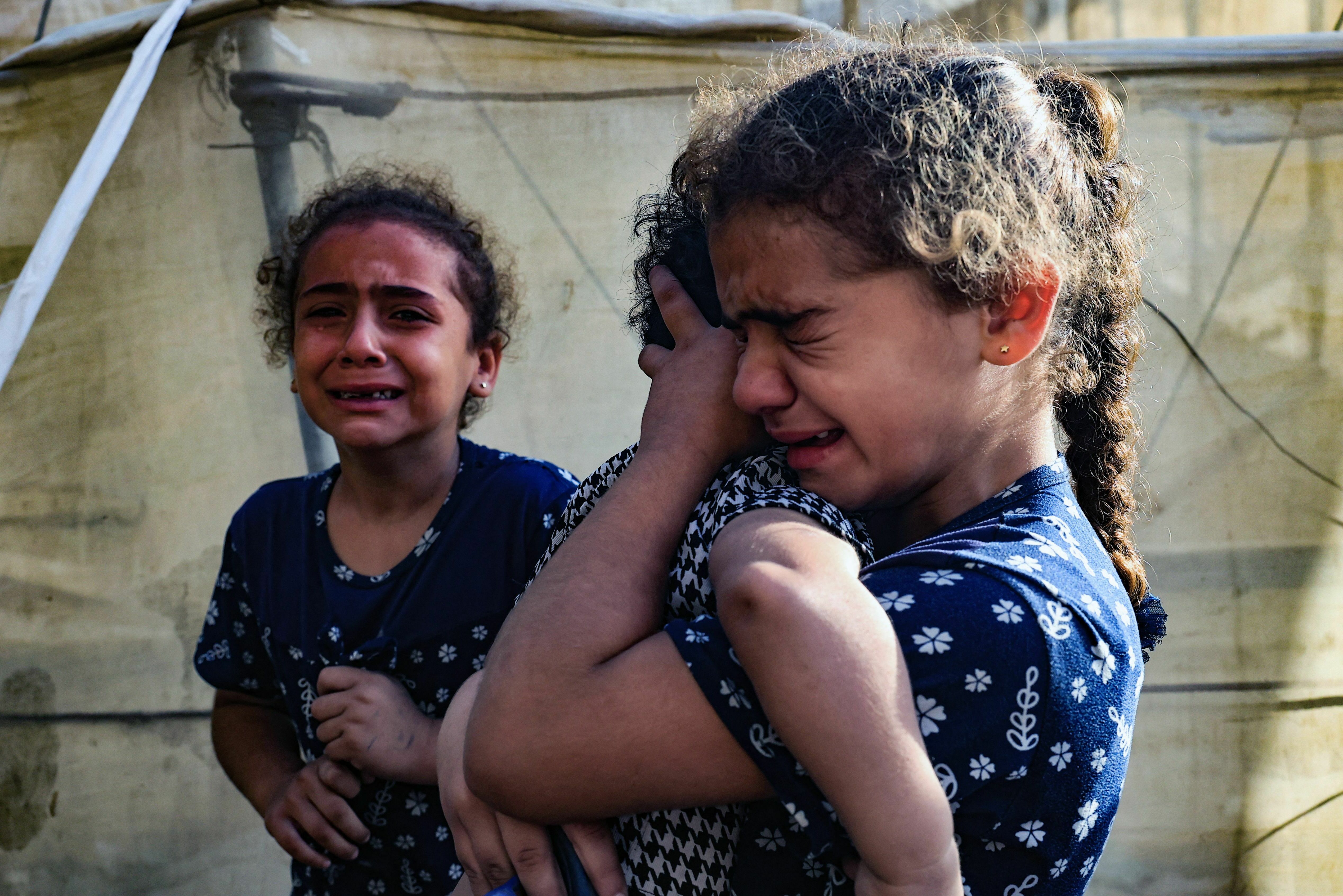 Sat., Nov. 11: Children react during the funeral of the Faojo family, killed in Israeli bombing on Rafah in the southern Gaza Strip.
