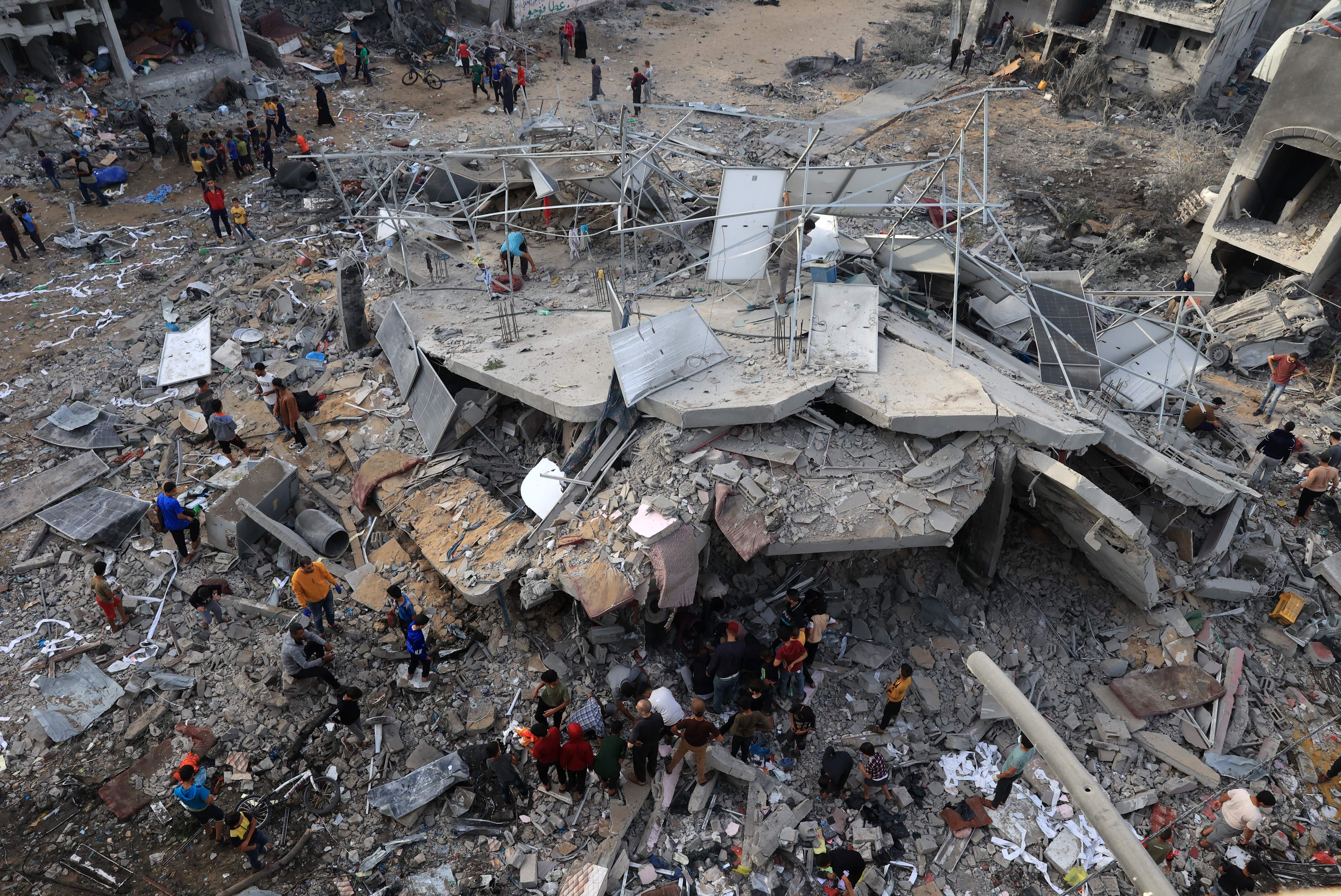 Sat., Nov. 11: This aerial picture shows people gathered around a destroyed building following Israeli bombing on Rafah in the southern Gaza Strip.