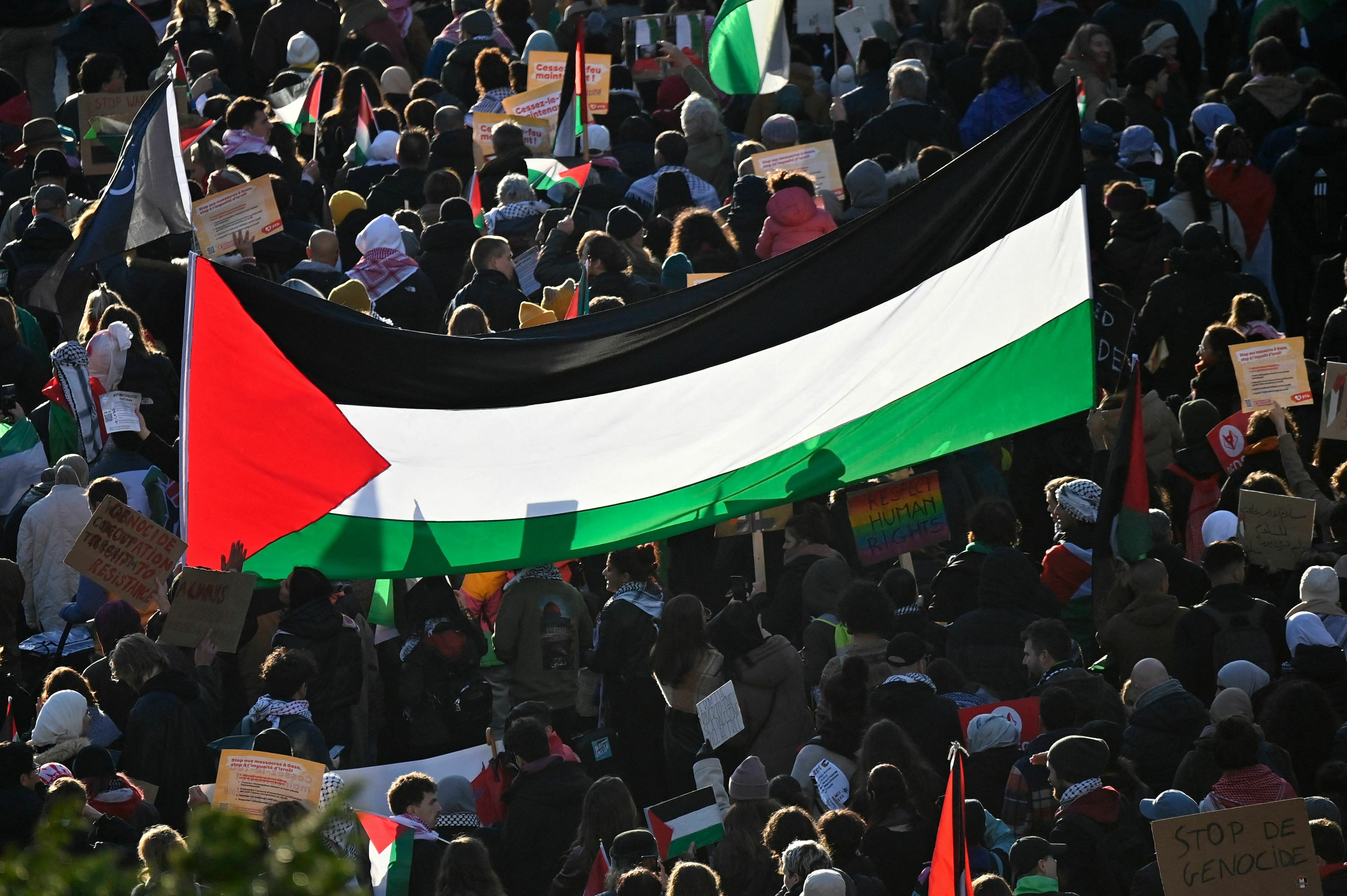Sat., Nov. 11: Protesters march with a giant Palestinian flag during a demonstration in support of Palestinians and to demand an immediate ceasefire in Gaza at Place de la Republique in Brussels.