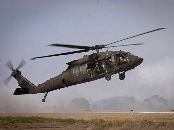 Military personnel of the U.S. Army's 101st Airborne Division take off with a Black Hawk helicopter during a demonstration drill at Mihail Kogalniceanu Airbase near Constanta, Romania on July 30, 2022. A Black Hawk helicopter crashed over the weekend in the Mediterranean Sea.