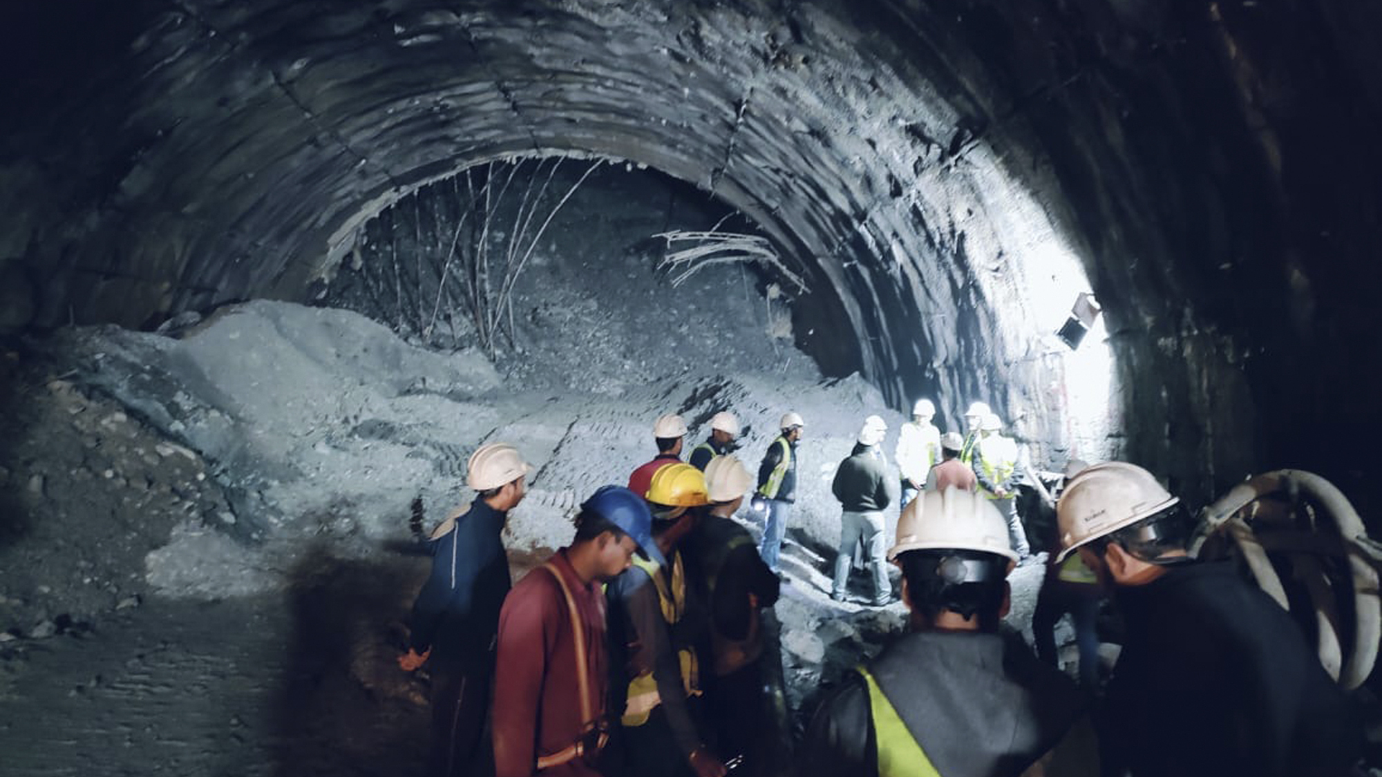 Rescuers dig to reach 40 workers trapped in collapsed road tunnel in north India 