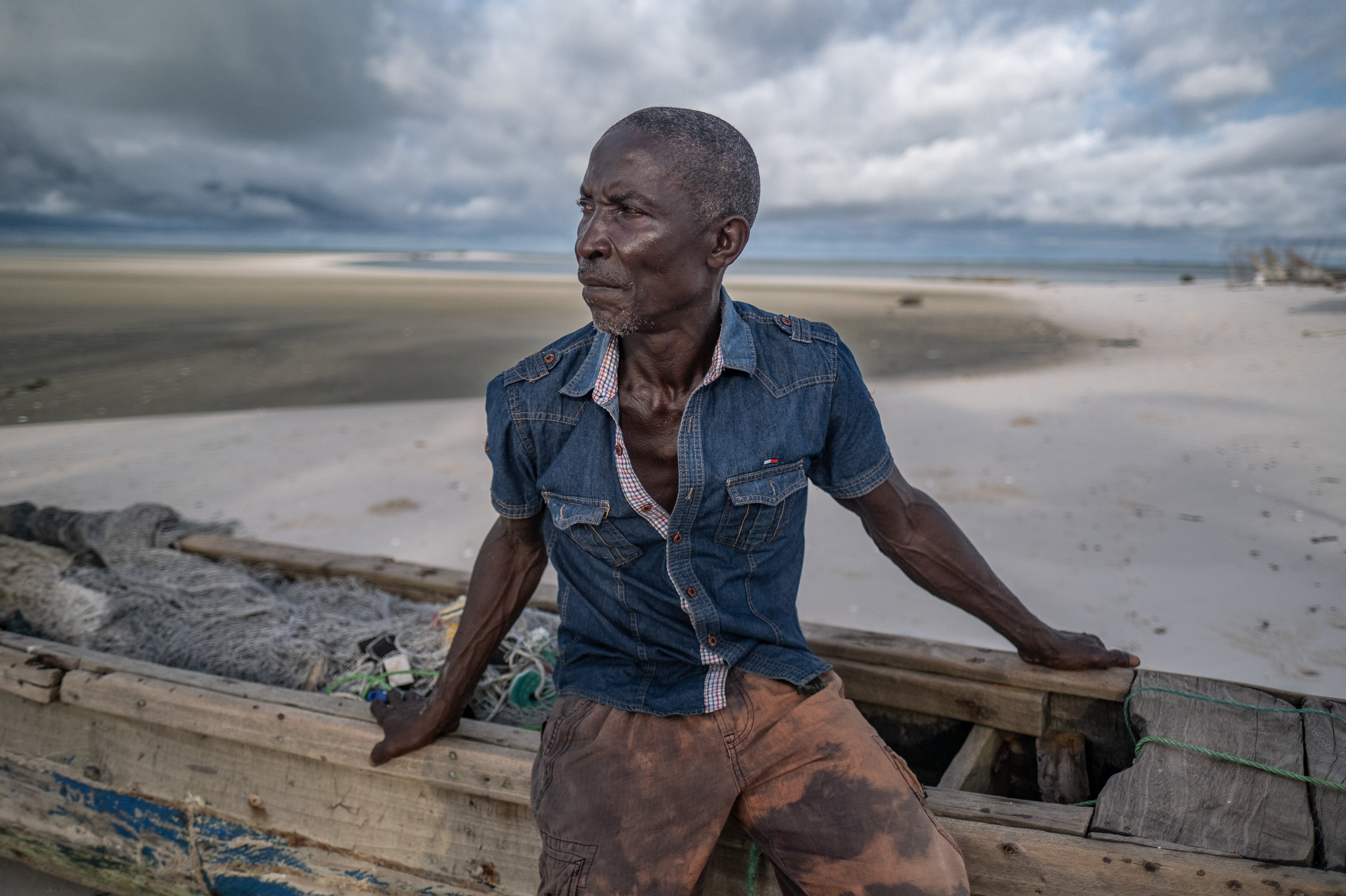 "It's getting worse and worse," says islander Kpana Charlie, a father of six who has lived in a makeshift home of sticks and tarpaulin since his previous home was washed away. "Whenever the water's high the place floods all over. It never used to happen like this."