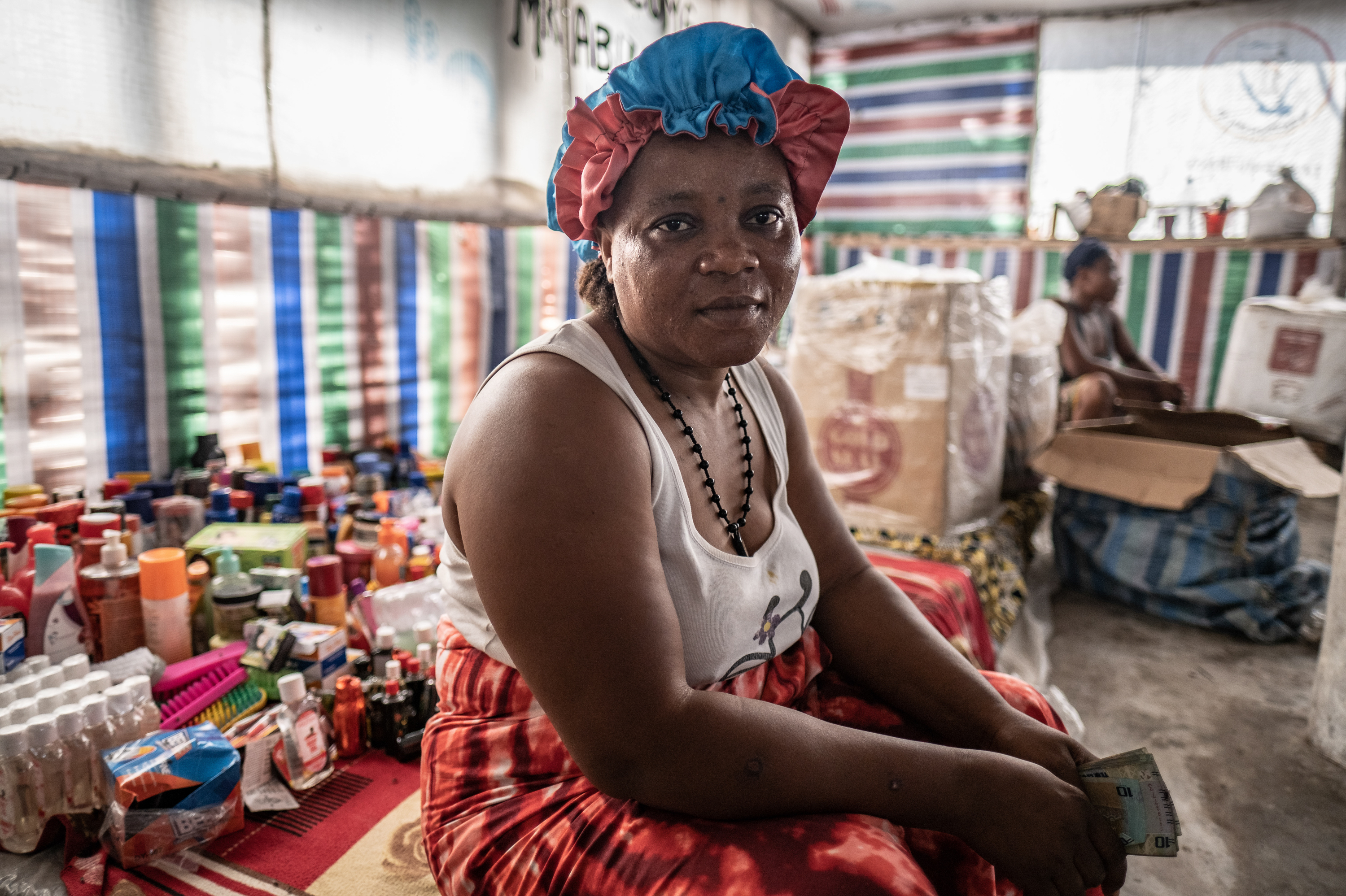 Shopkeeper Tene Kamara, 48, photographed in her shop on Nyangai island, Sierra Leone. Kamara has been building her business here for the past 15 years, but most of her customers have now fled the island as the sea erodes it away. "I'd leave tomorrow if I could," said Kamara. "I'm afraid, and it makes my heart worry."