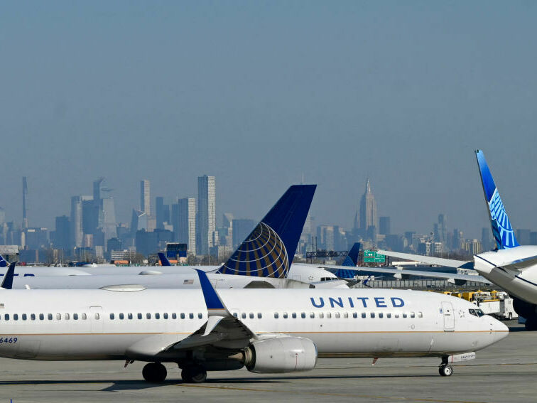 United Air Lines planes line up along the busy Newark Liberty International Airport, New Jersey, on the eve of Thanksgiving on November 23, 2022. (AFP via Getty Images)