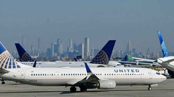 United Air Lines planes line up along the busy Newark Liberty International Airport, New Jersey, on the eve of Thanksgiving on November 23, 2022.