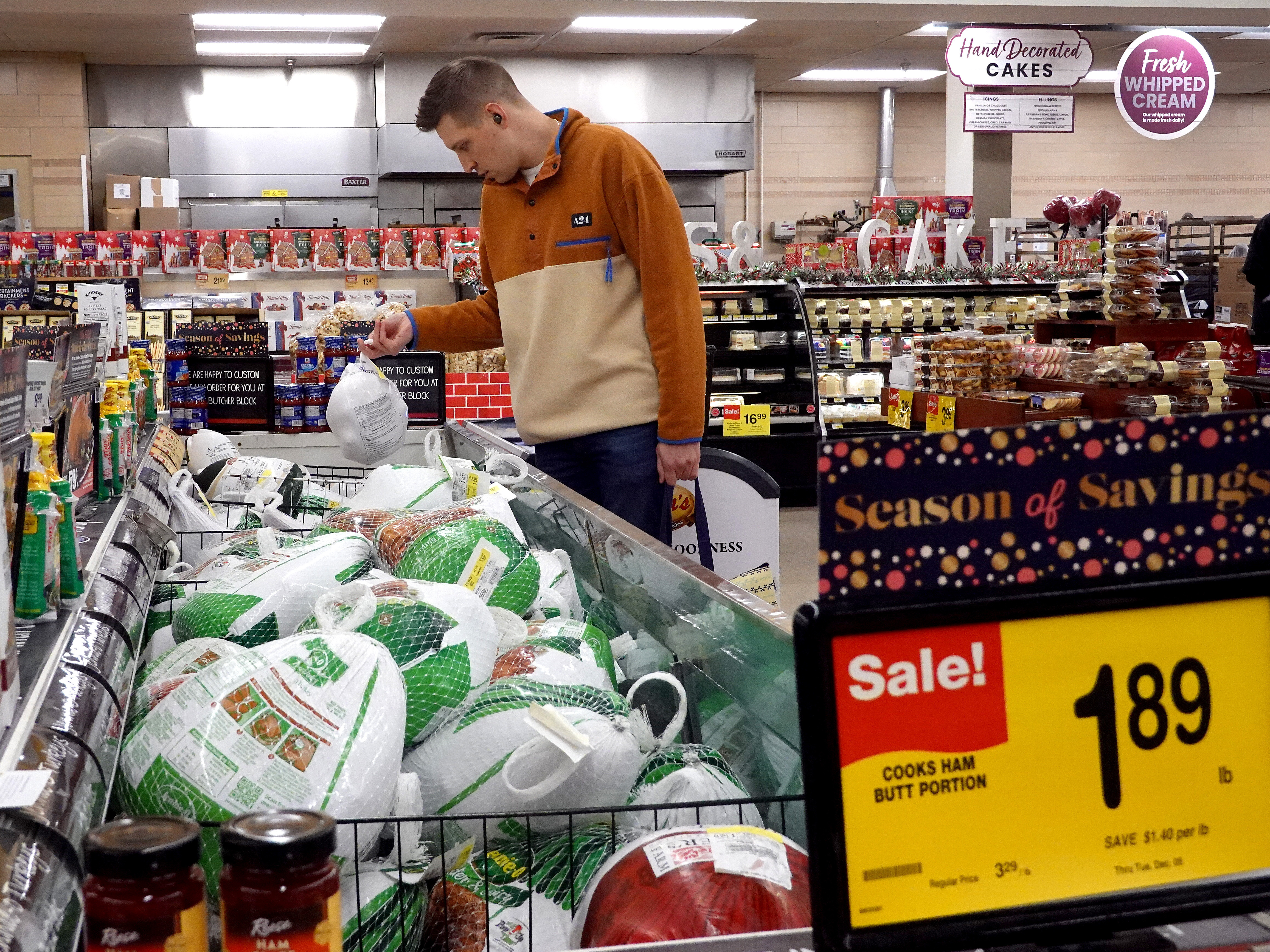 A customer in Chicago looks for turkeys offered for sale on Nov. 20, 2023, ahead of the Thanksgiving holiday. Turkey prices have fallen — but the cost of many groceries are still higher. (Getty Images)