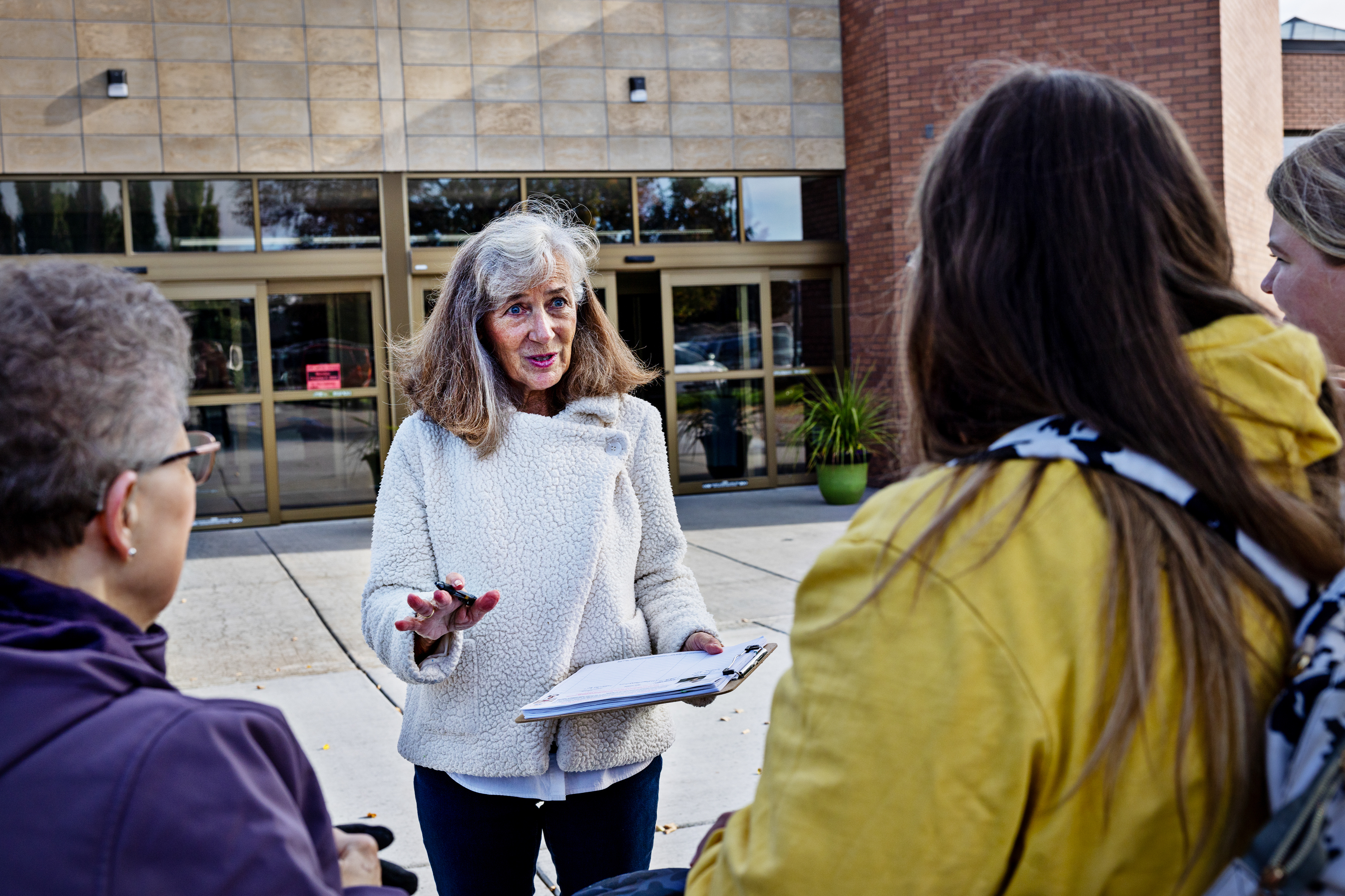 Parents Against Bad Books co-founder Carolyn Harrison (center) talks with people last month outside the public library in Idaho Falls, Idaho, about what she considers obscene books on the shelves. (Kim Raff for NPR)