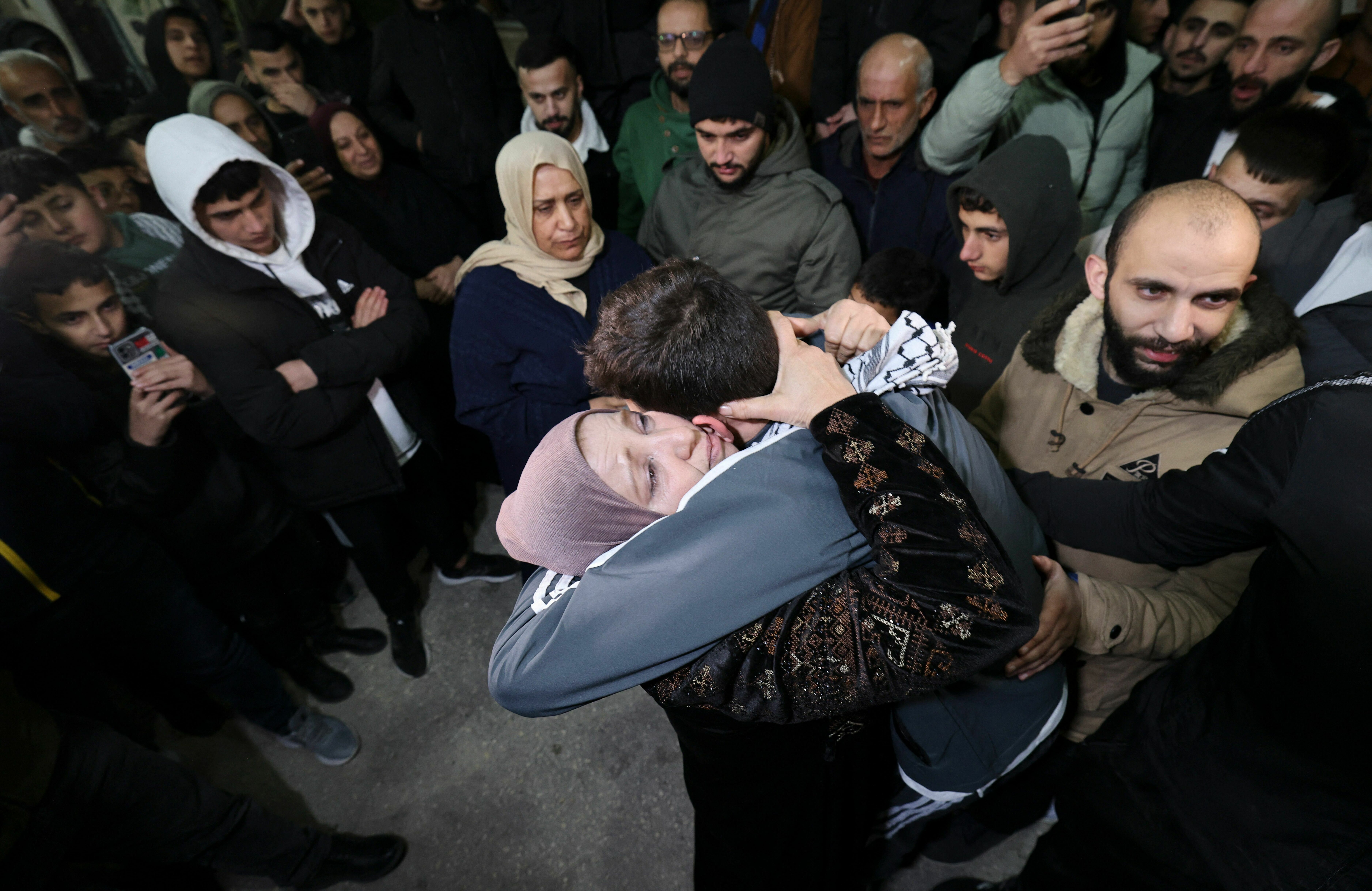 Palestinian prisoner Khalil Zama, right, hugs his mother after being released from an Israeli jail in exchange for Israeli hostages released by Hamas from the Gaza Strip, at his home in Halhul village north Hebron in the occupied West Bank on Monday. (AFP via Getty Images)