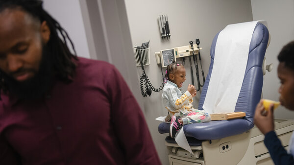A family waits in a doctor's office.