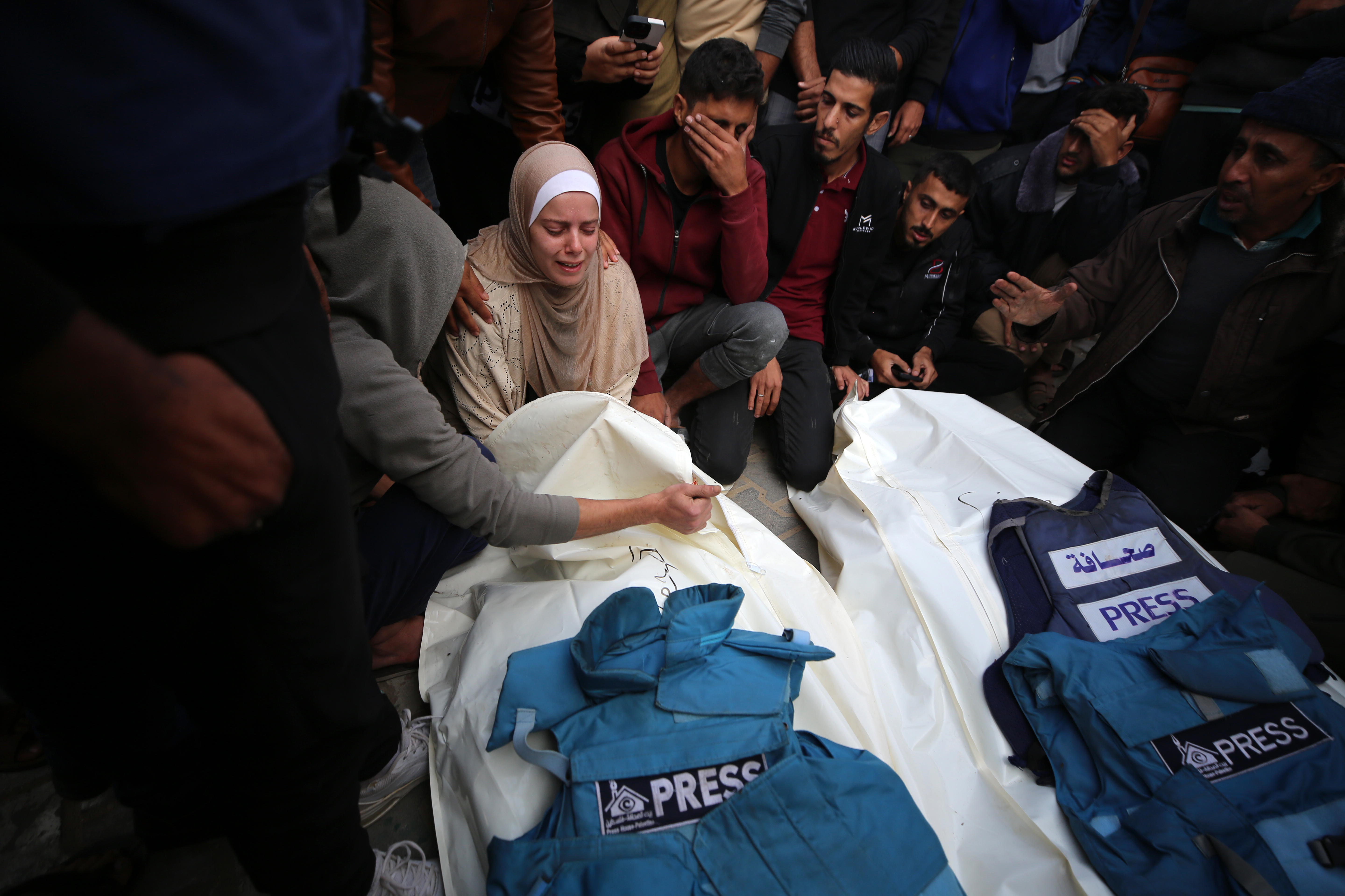 Journalists, relatives and friends pray over the bodies of journalists Sari Mansour and Hassouna Esleem after they were killed in an Israeli bombardment at Bureij camp in the central Gaza Strip on Nov. 19. (Majdi Fathi/NurPhoto via Getty Images)