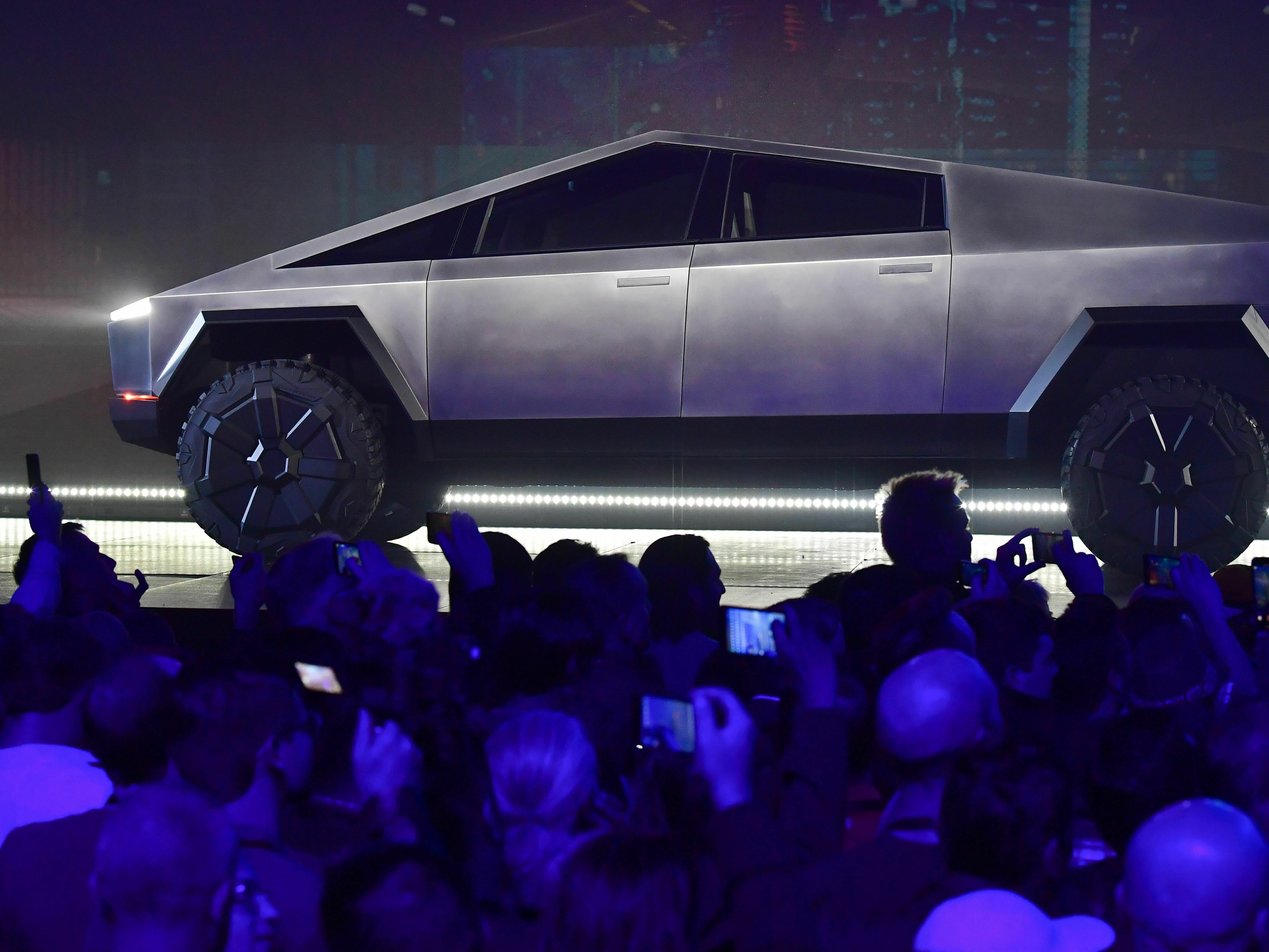 Tesla's Cybertruck, pictured here during its design reveal in Hawthorne, Calif., in 2019, is finally rolling out of factories a full two years after the initial delivery target. (AFP via Getty Images)