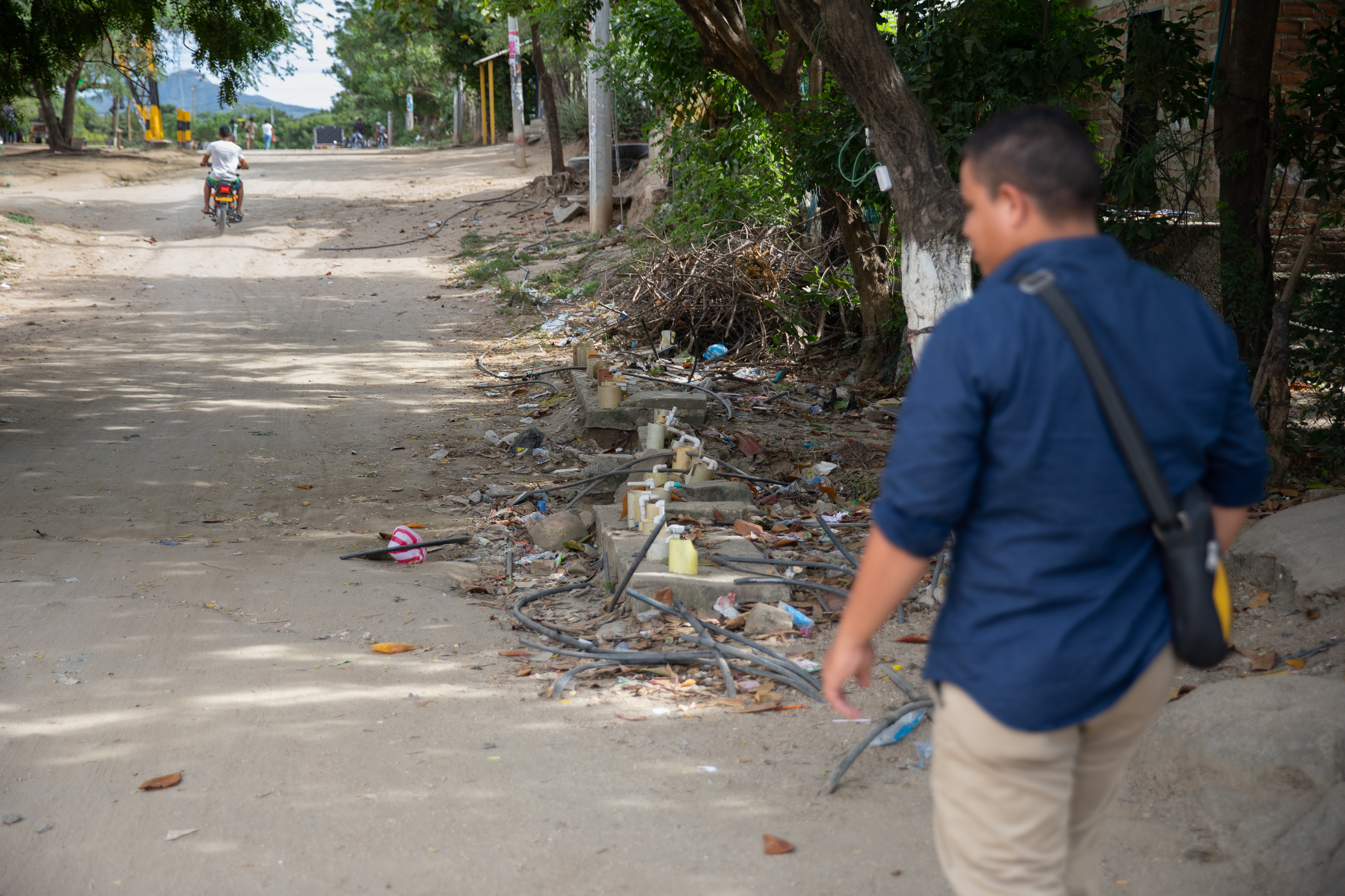Community leader Carlos Ramos stands by one of the major water connection points in La Paz, where residents hook up their motor pumps to push water from the main pipe through their hoses into their home cisterns hundreds of feet away.