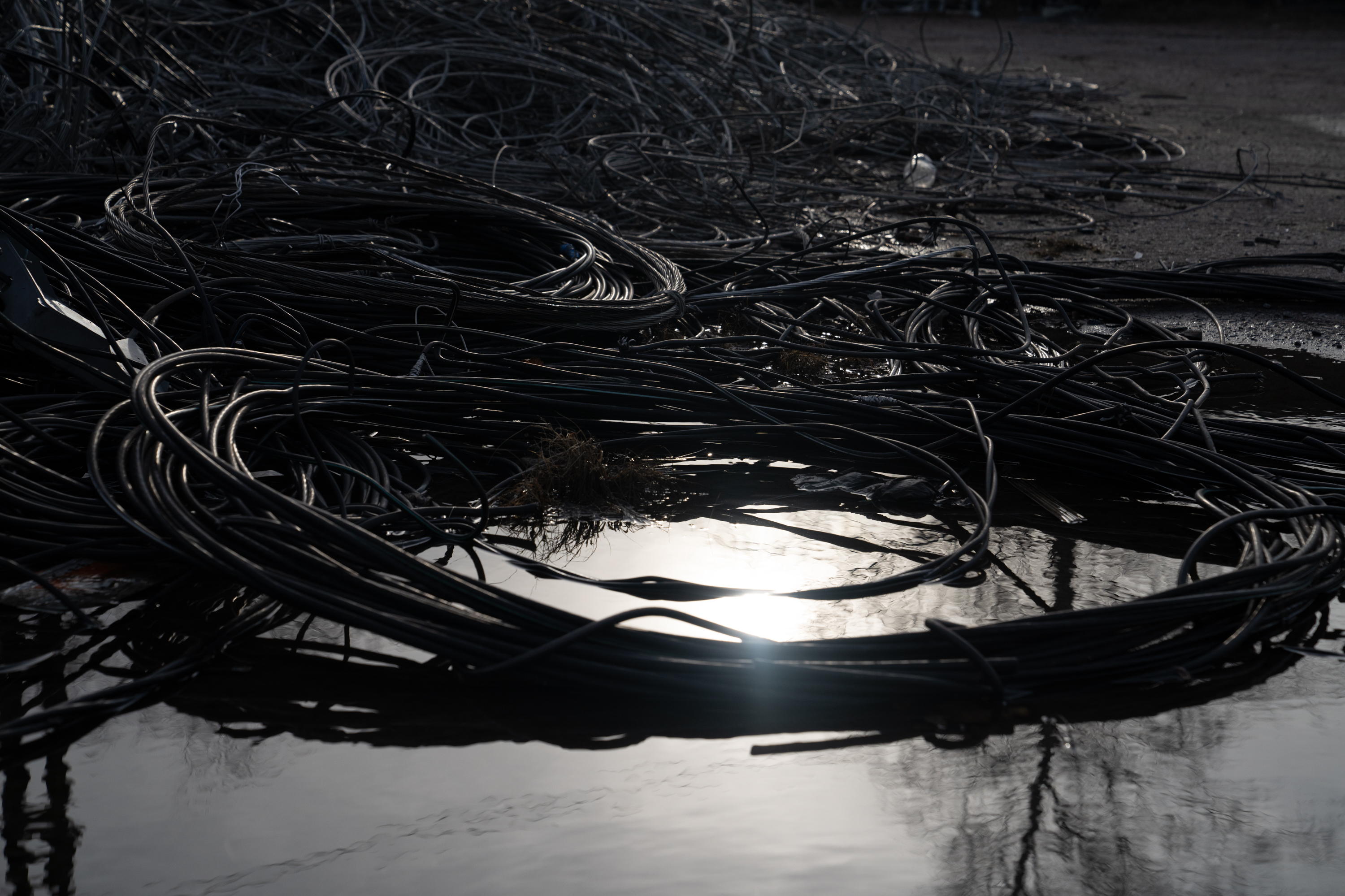 Ukraine is trying to keep its lights on this winter. Russia aims to turn them off 6 Piles of used and damaged wires are set aside to be recycled in a lot in Lyman.
