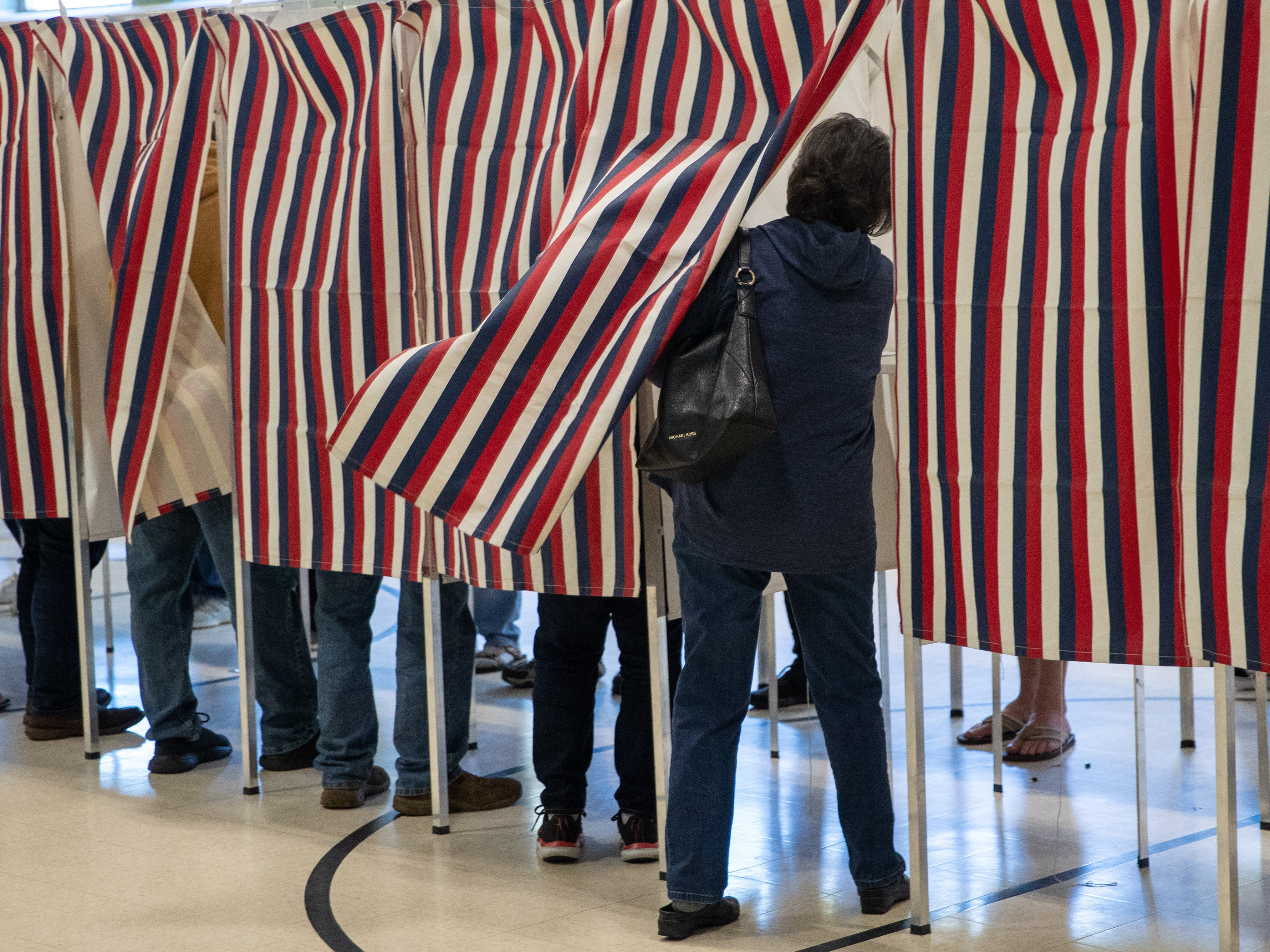 A voter enters a booth to fill out their ballot in Manchester, N.H., in 2022. (Getty Images)